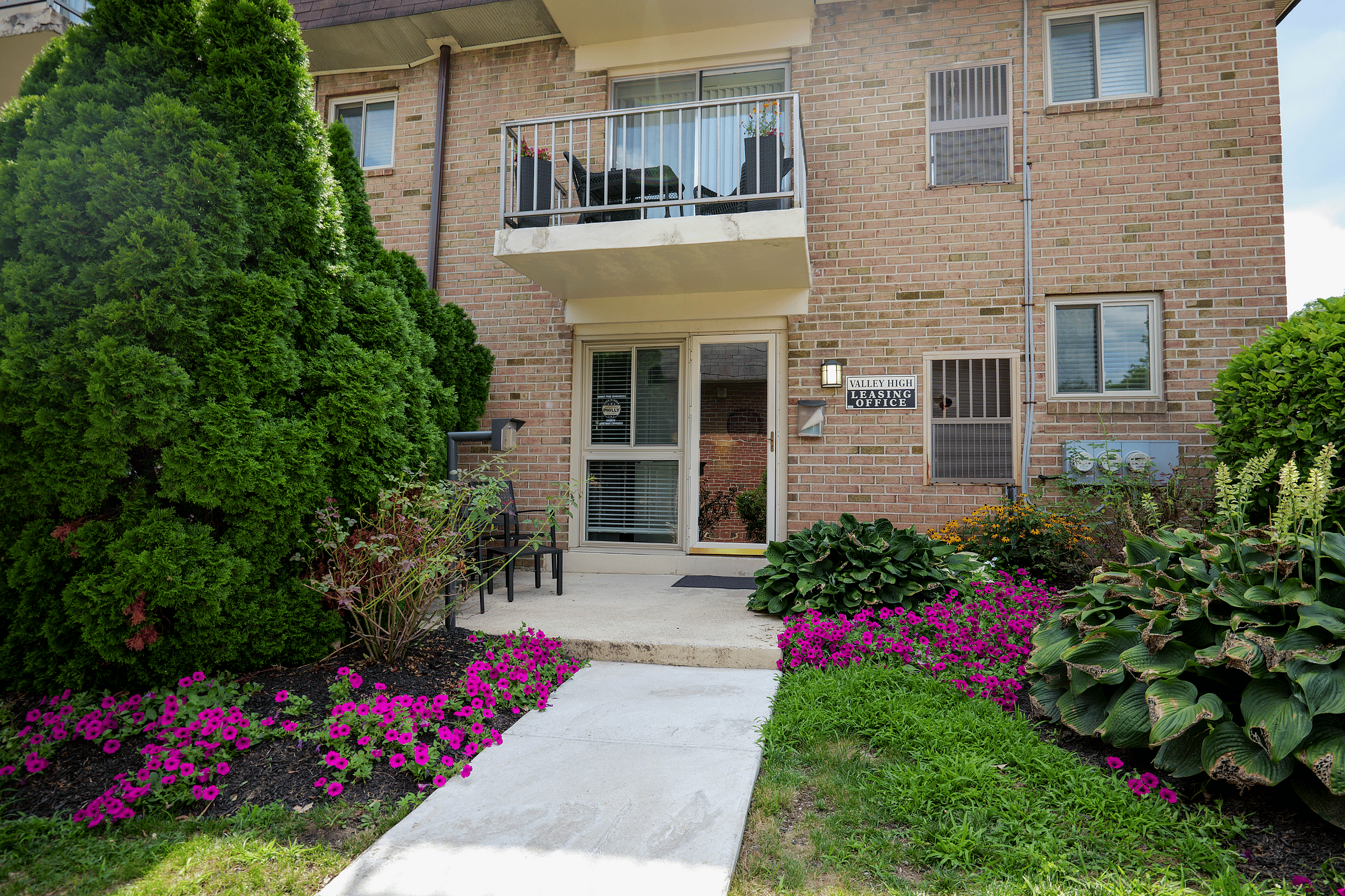 Front view of Valley High Apartments showing private entrances and scenic landscaping