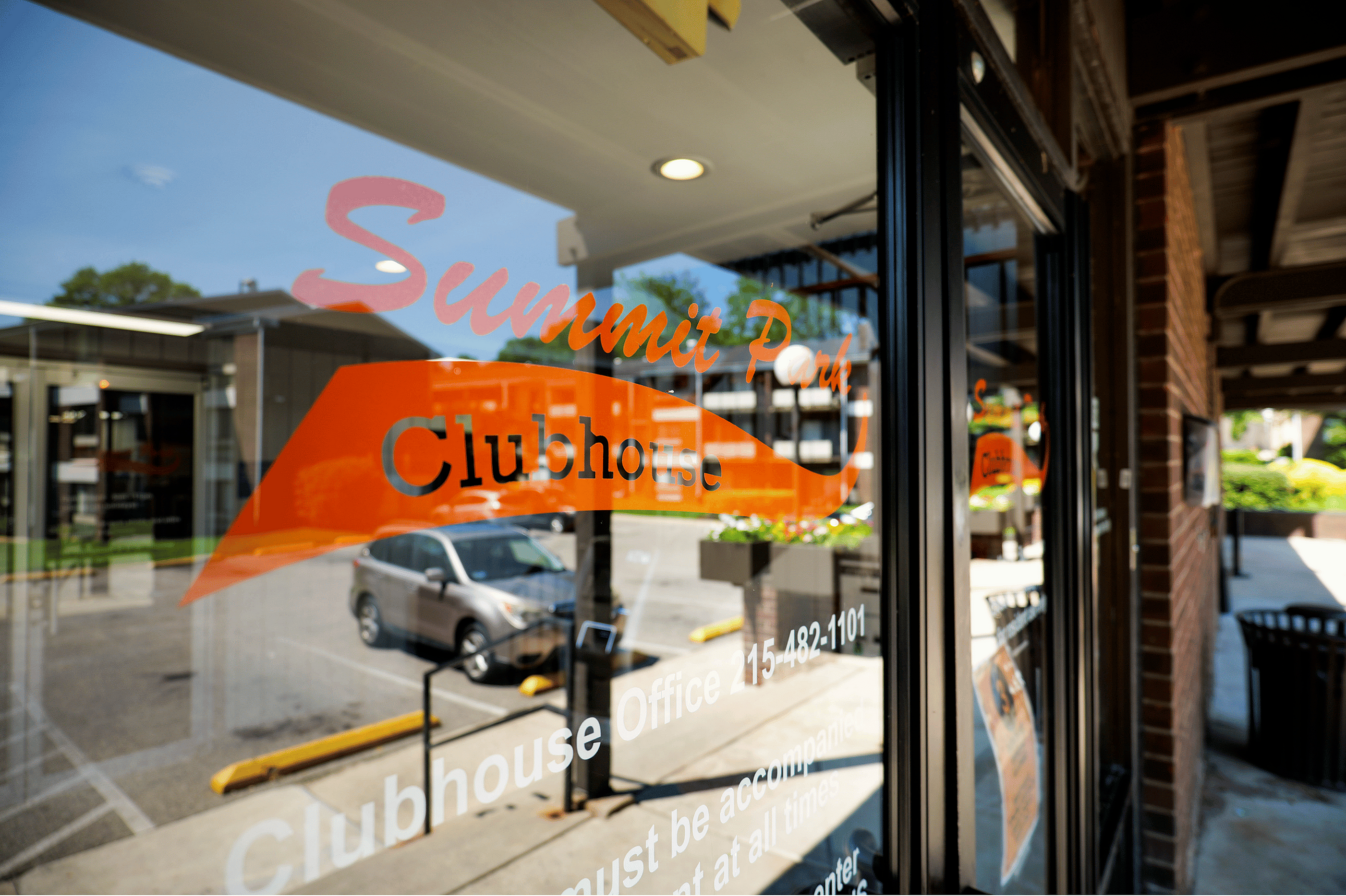 Inviting view of Summit Park Clubhouse entrance with clear signage and a modern exterior.