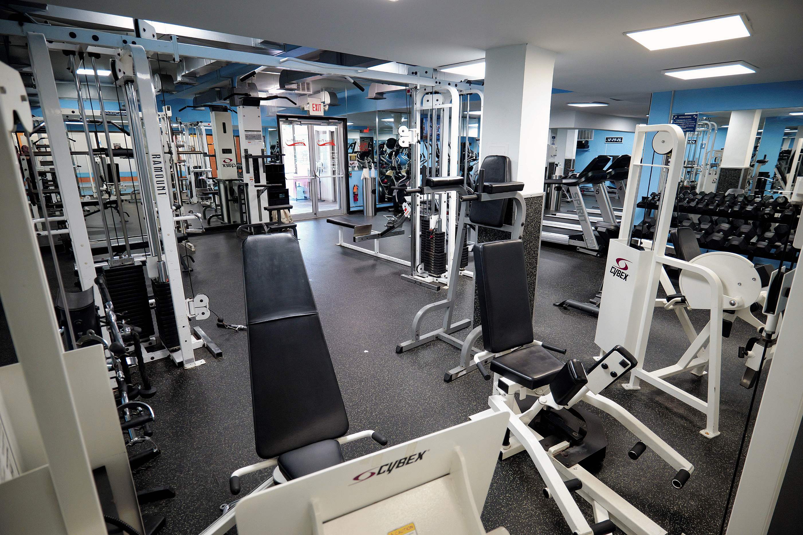 Modern fitness center with high-quality exercise equipment and ample natural light, perfect for an invigorating workout.