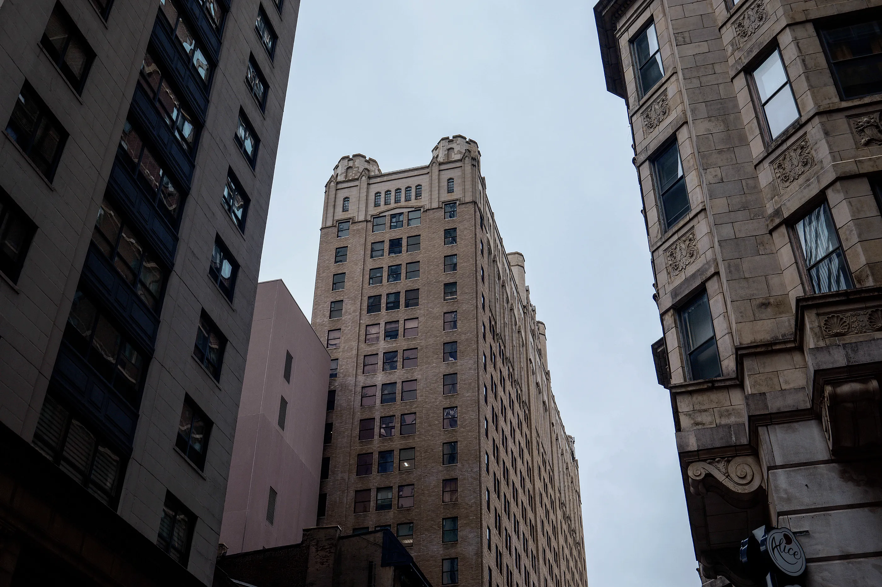 Charming urban view highlighting a historic high-rise building with classic architectural details, nestled between neighboring structures.