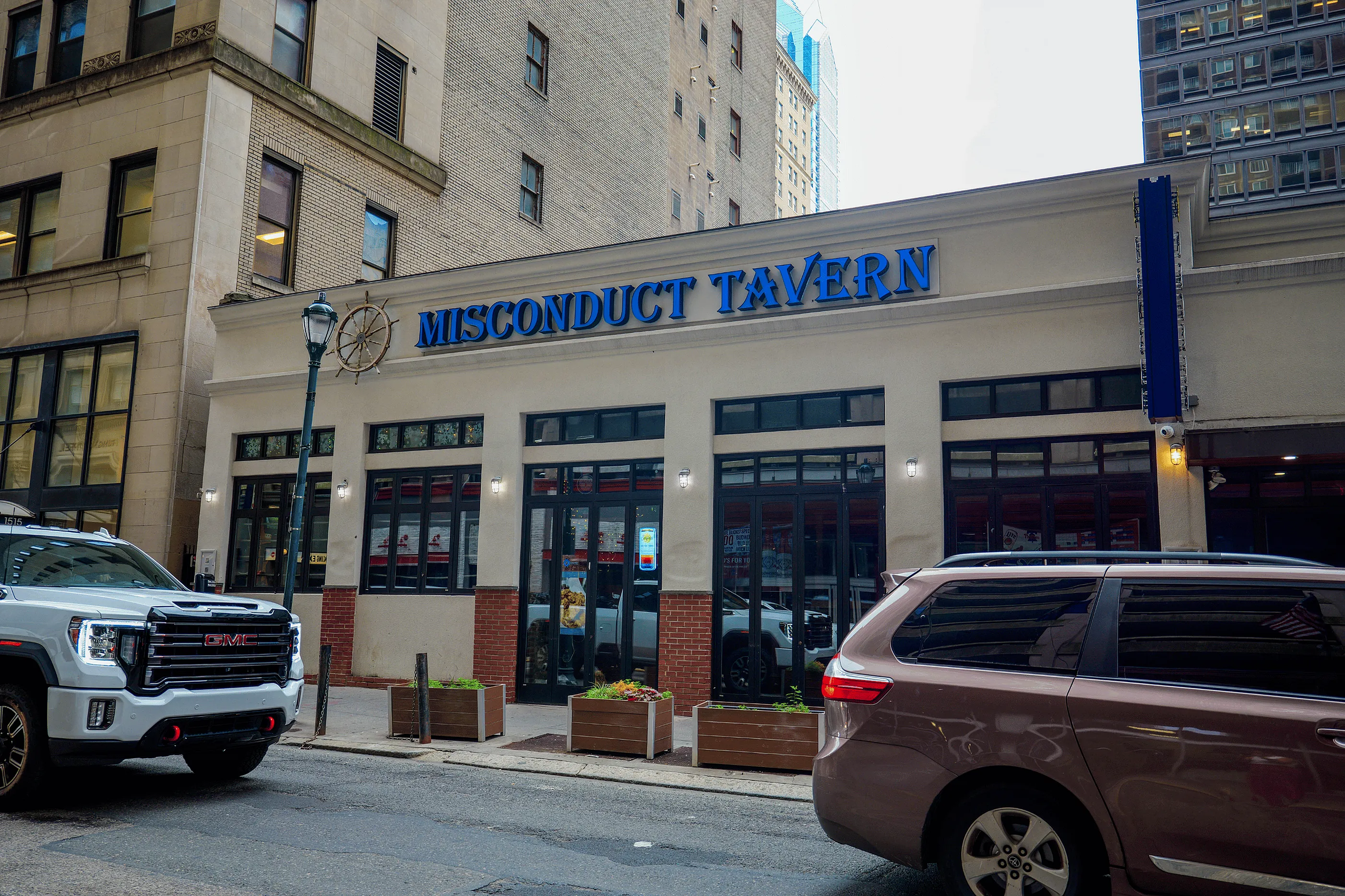 Inviting city view of Misconduct Tavern's charming exterior with large windows and a vibrant atmosphere.