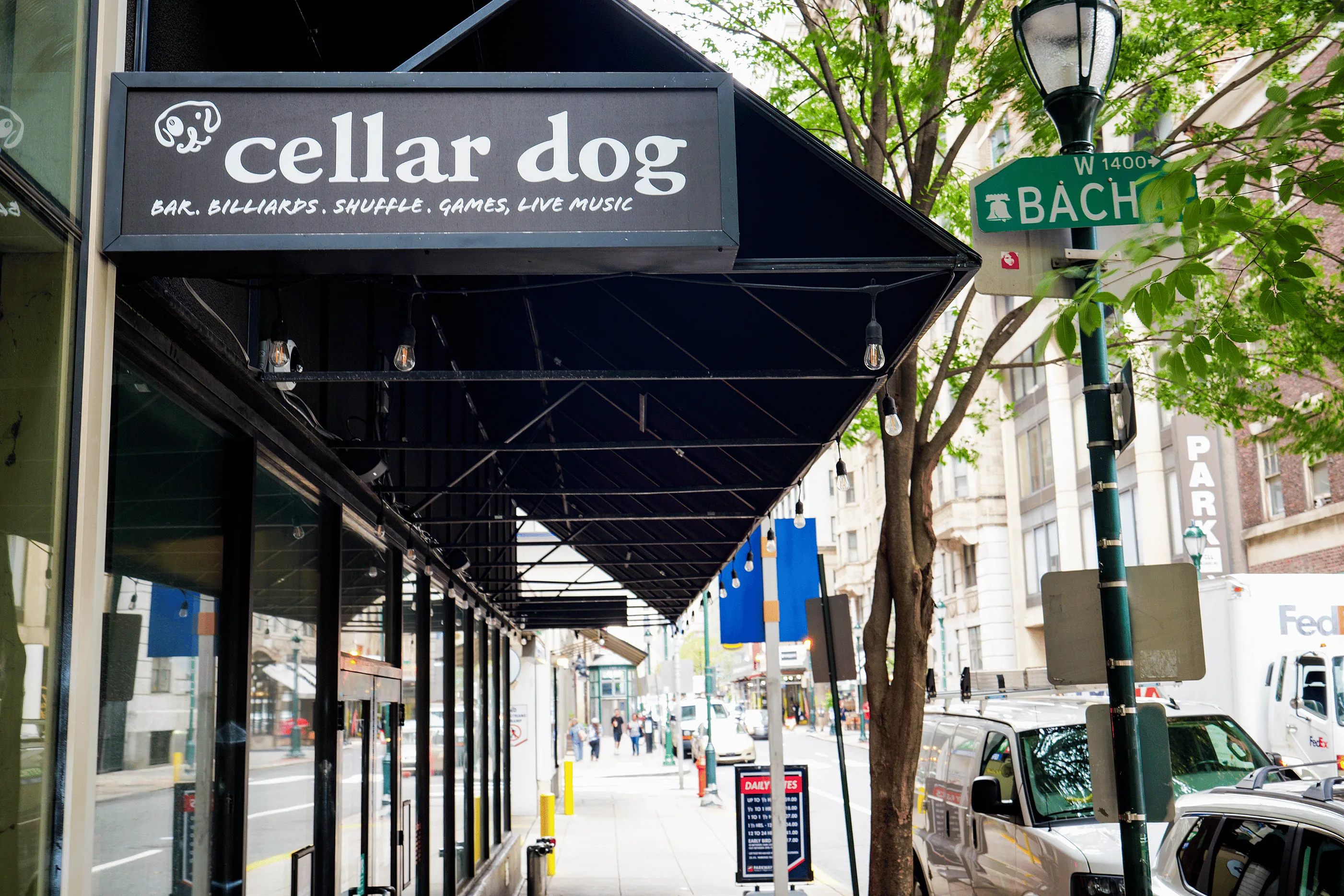Charming urban street with a vibrant bar and game venue, perfect for entertainment and socializing.