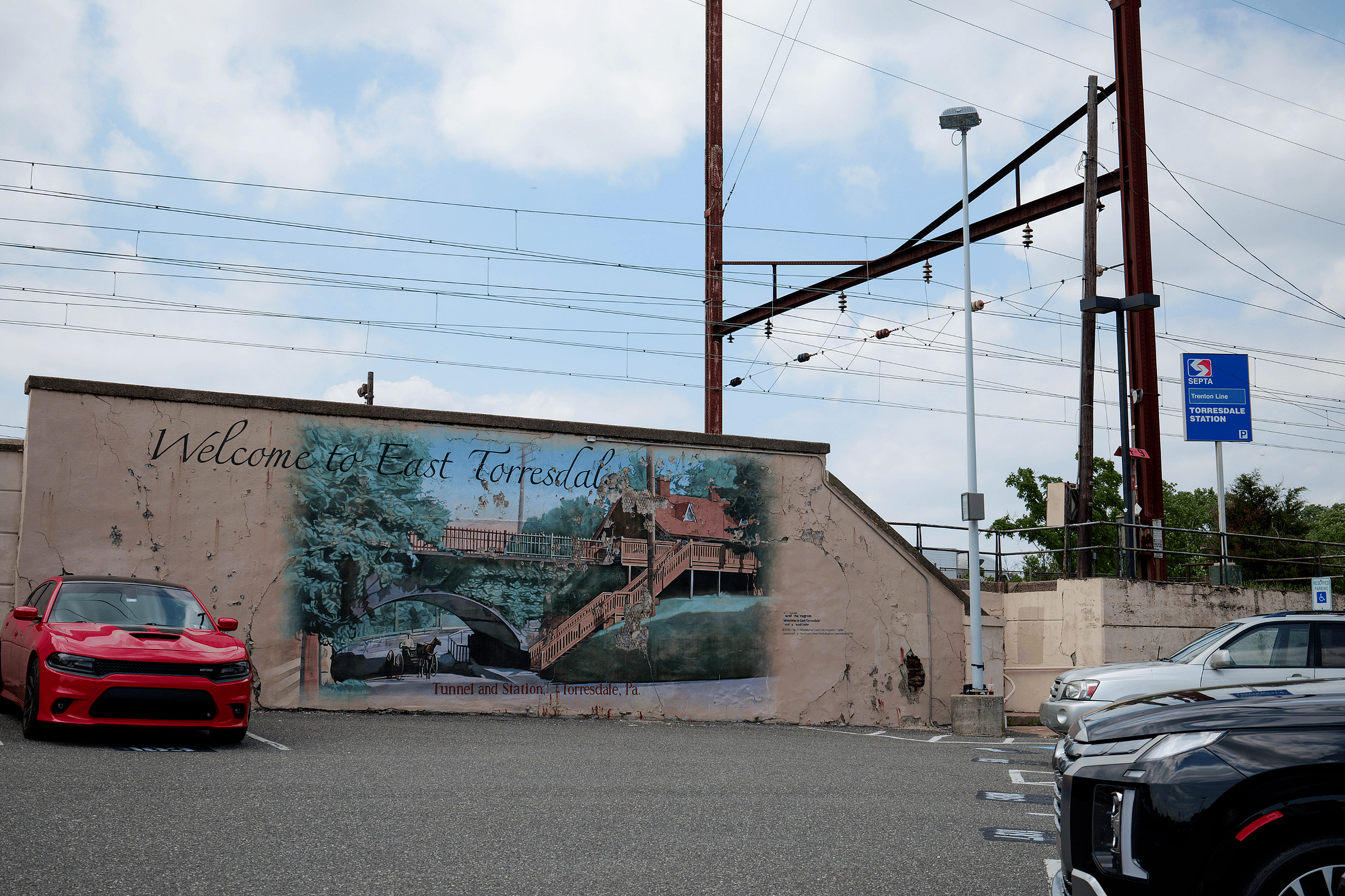 Vibrant mural welcomes you to East Torresdale alongside the Torresdale Station, capturing local charm and community artistry.