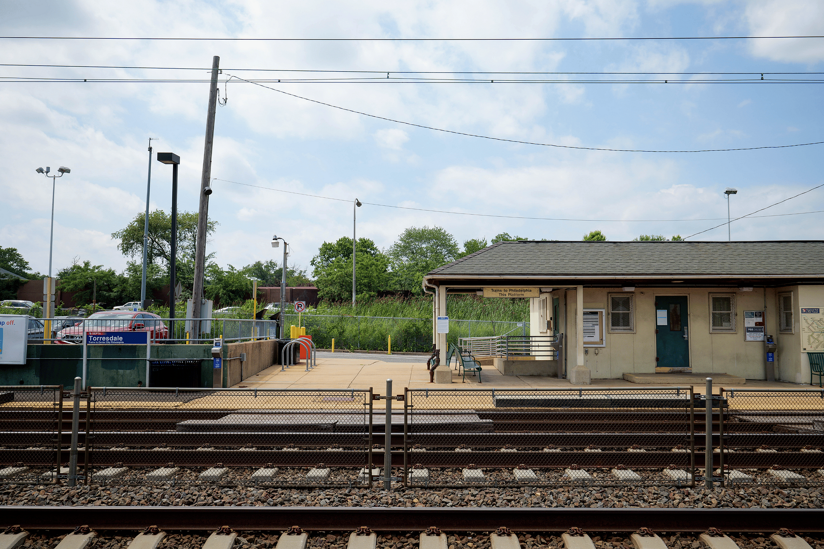 Charming train station platform surrounded by lush greenery, offering a serene and convenient commuting experience.