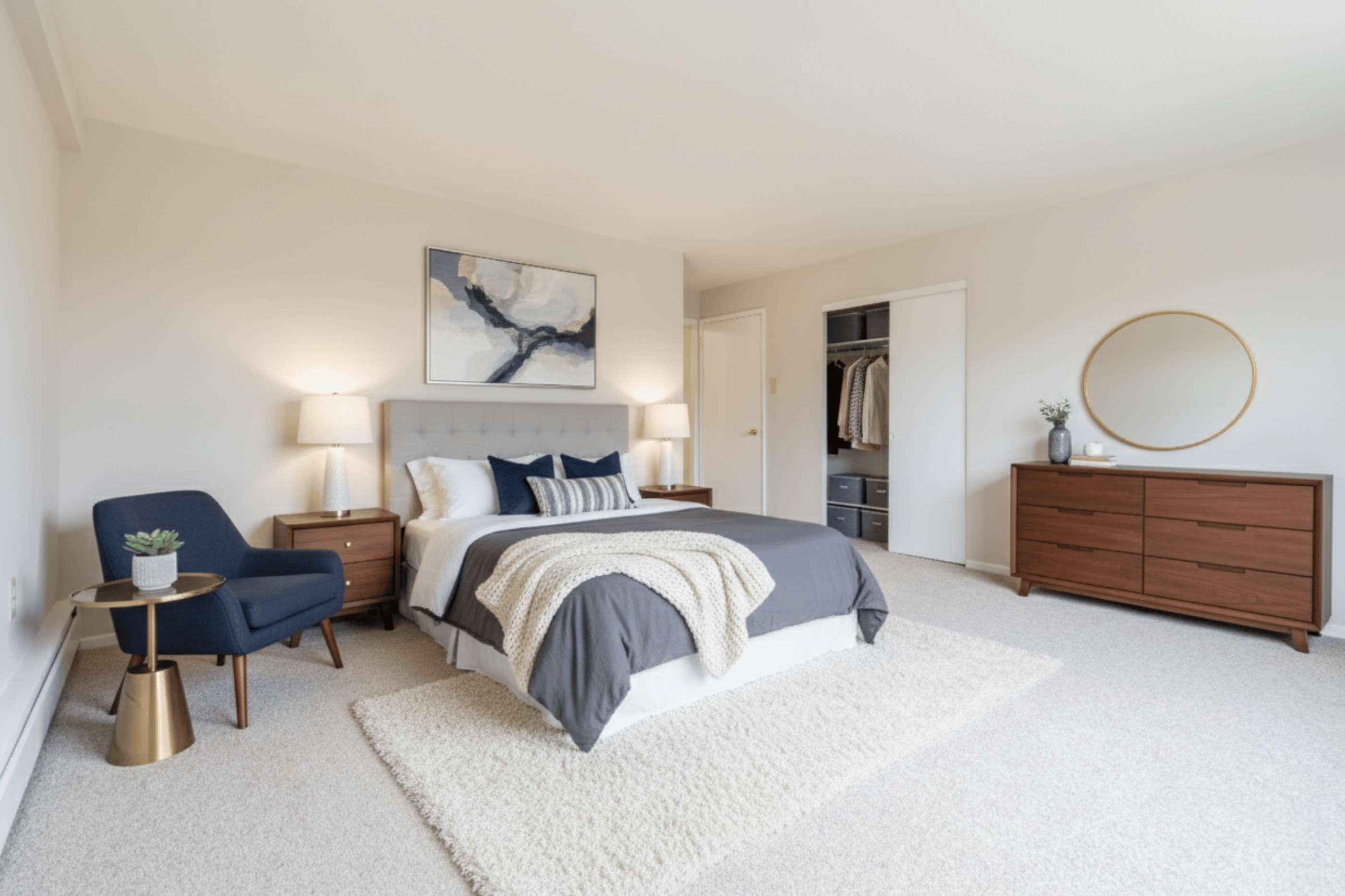 Inviting bedroom with elegant decor featuring a cozy bed, modern furniture, and warm lighting.