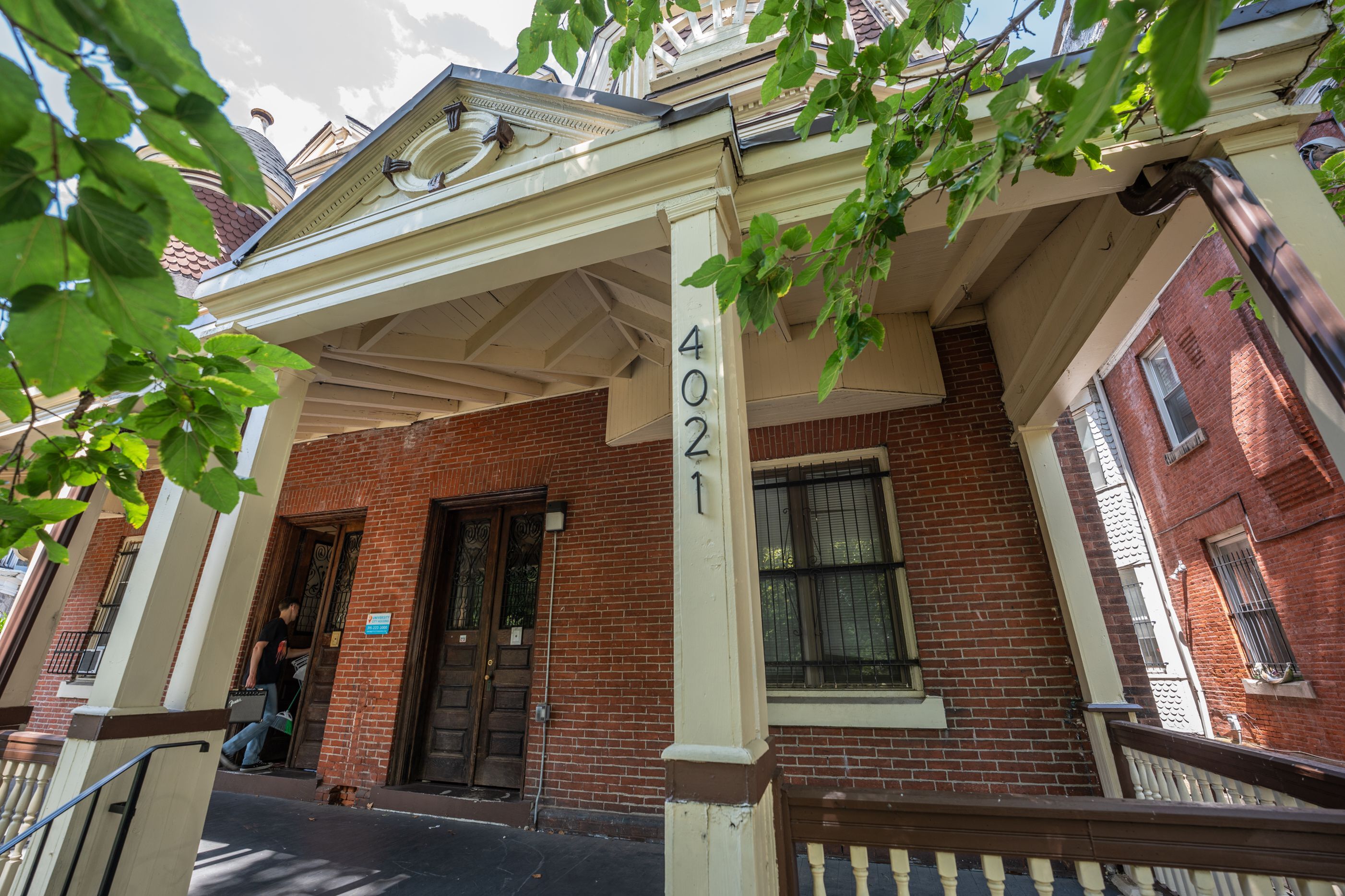 Charming brick townhouse with classic architectural details and inviting front porch.