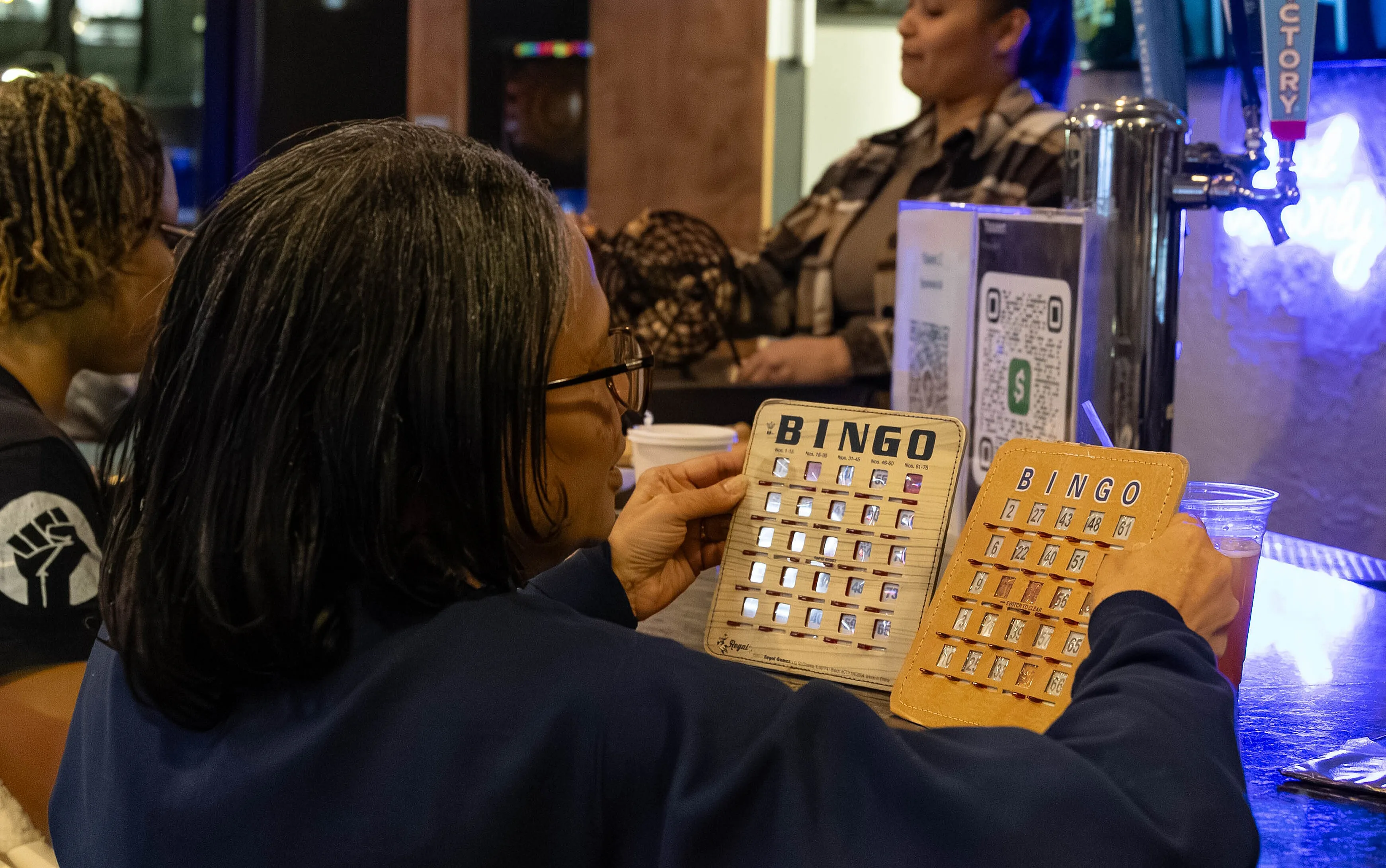 Engaging game of bingo at a fun social event in a lively bar atmosphere.