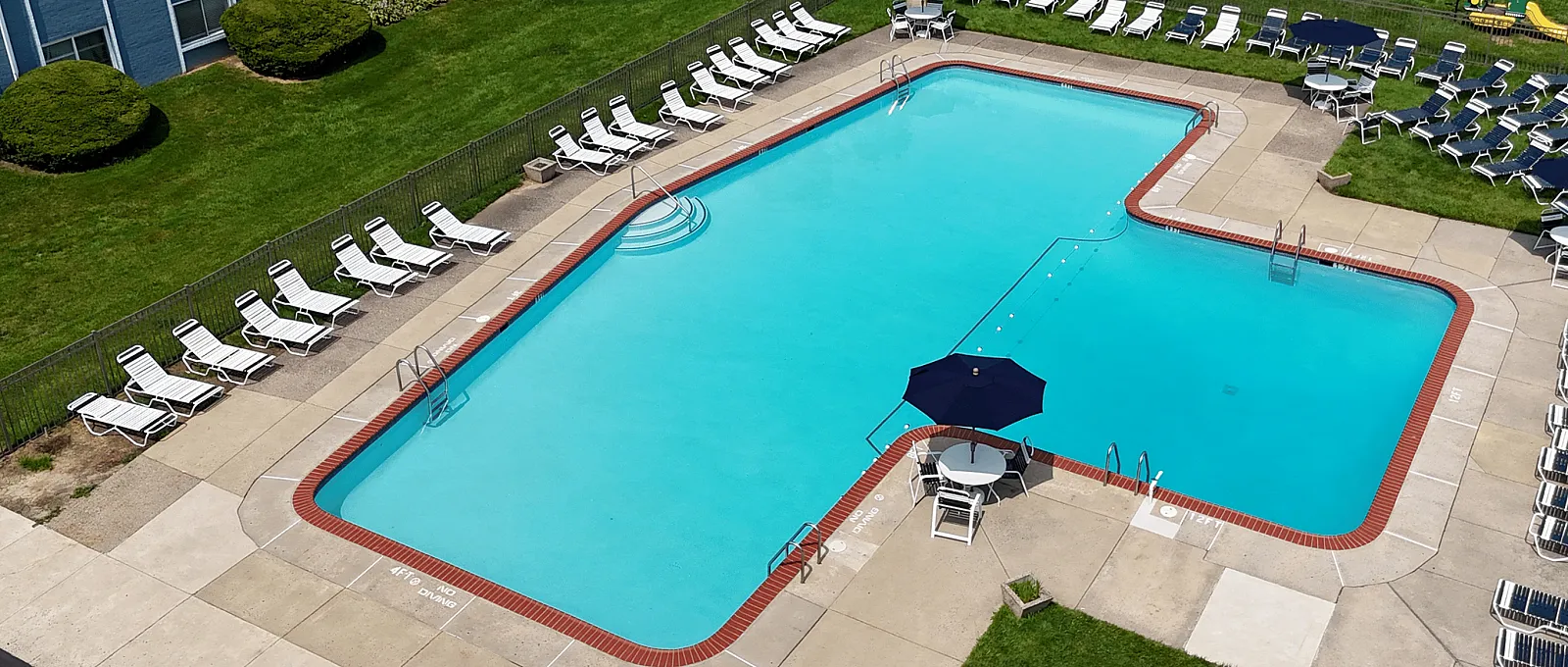 Beautiful one and two bedroom apartment homes at Arbor Lane apartments pool side picture on sunny day afternoon
