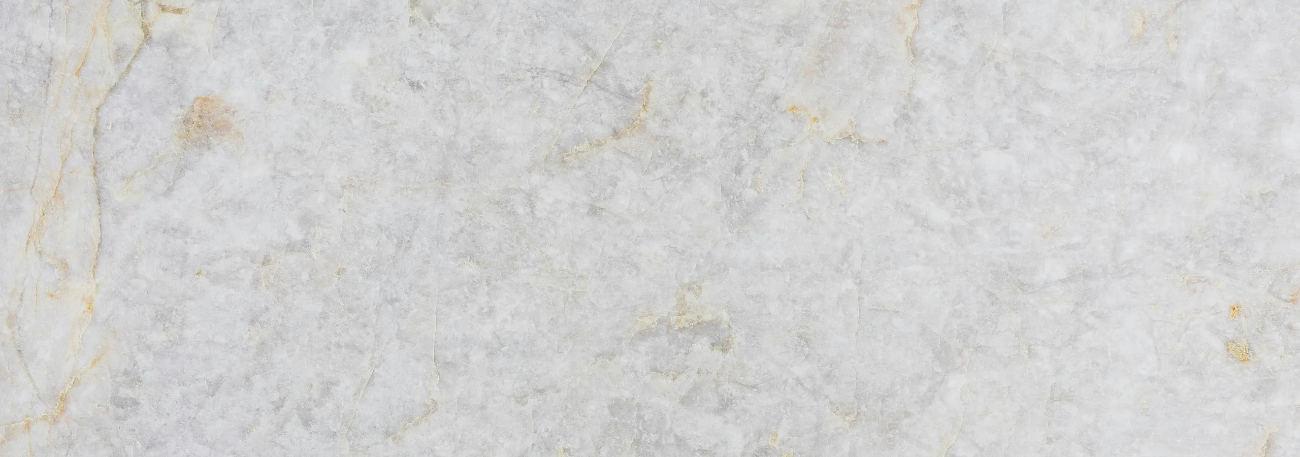 Elegant light gray marble surface with subtle veins and natural texture, ideal for luxury interior design.