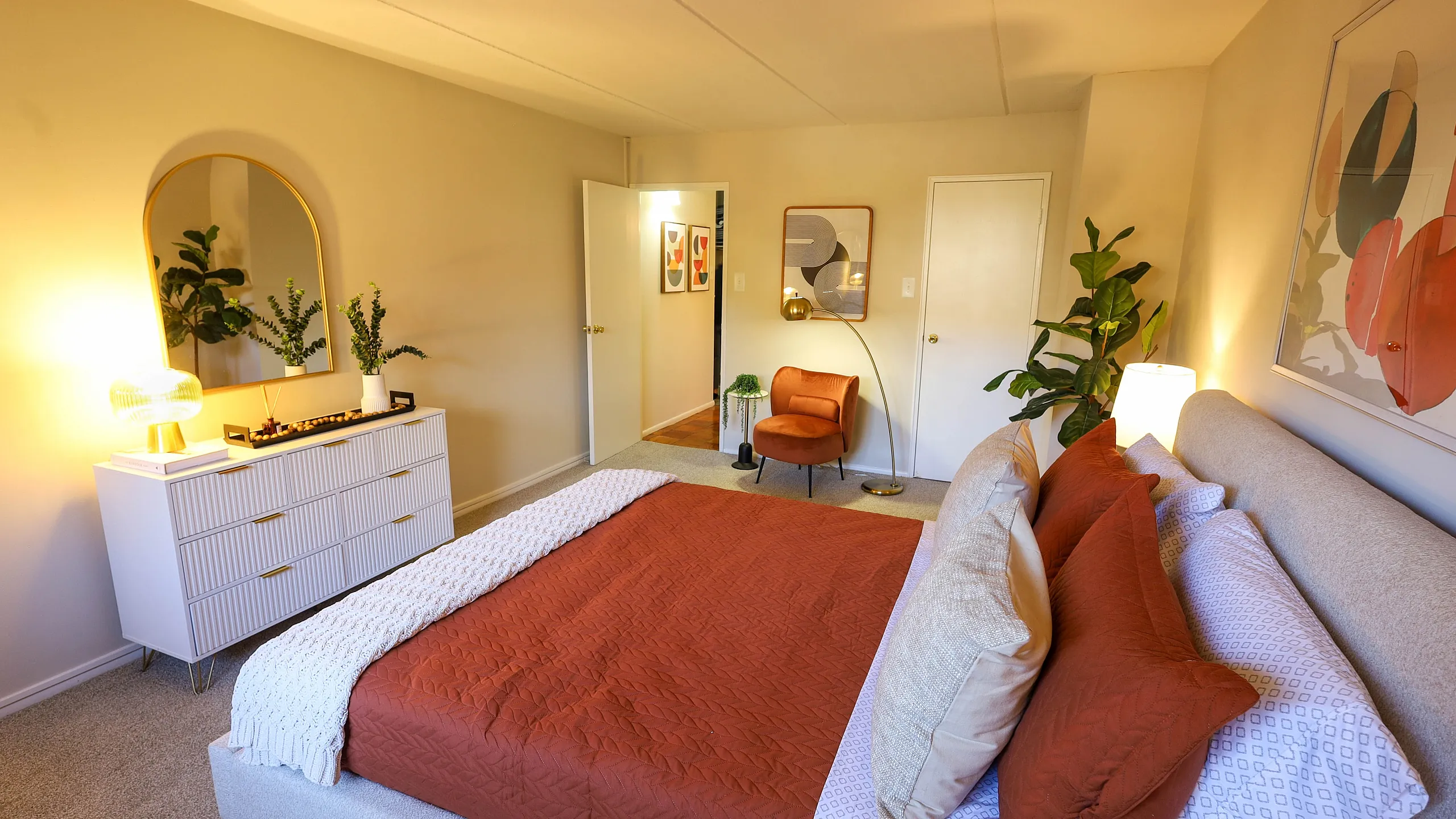 Cozy bedroom with an orange accent theme, featuring elegant furniture, ambient lighting, and stylish decor.