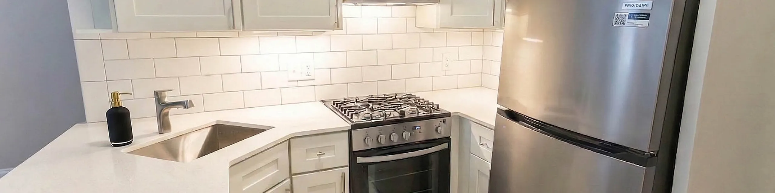 Modern kitchen featuring sleek cabinetry, stainless steel appliances, and elegant tiled backsplash for a contemporary look.