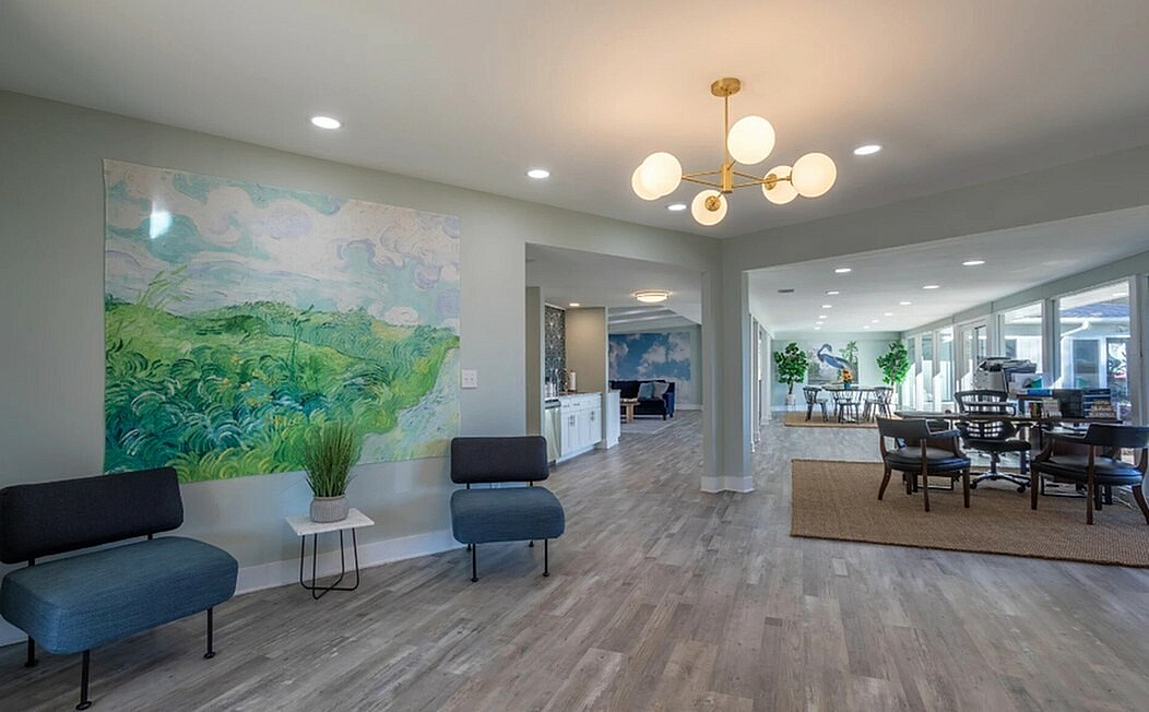 Bright, open-concept living space featuring modern decor with stylish lighting, cozy seating, and vibrant wall art in an inviting atmosphere.