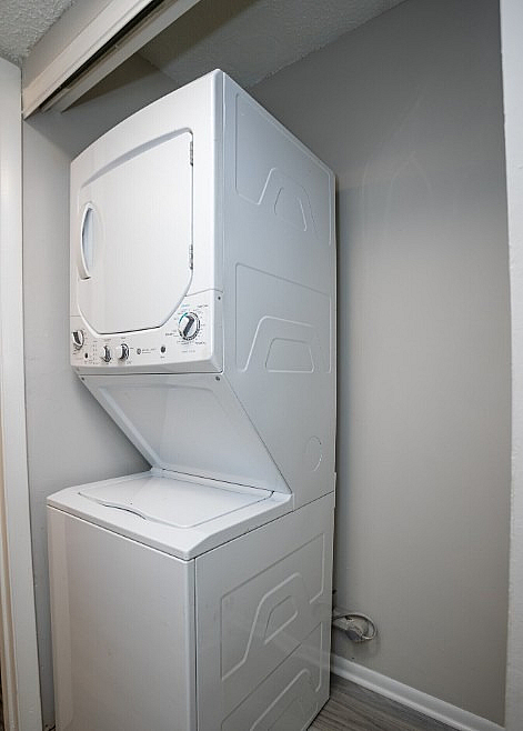 Modern apartment featuring a sleek, compact stacked washer and dryer in a convenient laundry nook.