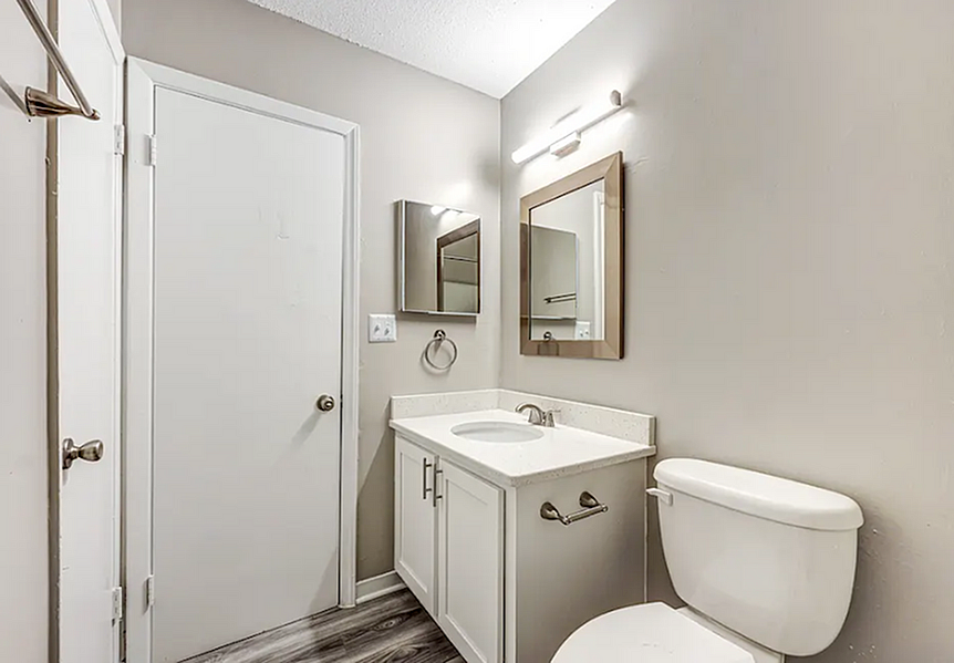 Elegant bathroom with modern vanity, sleek fixtures, and soft lighting creating a serene atmosphere.