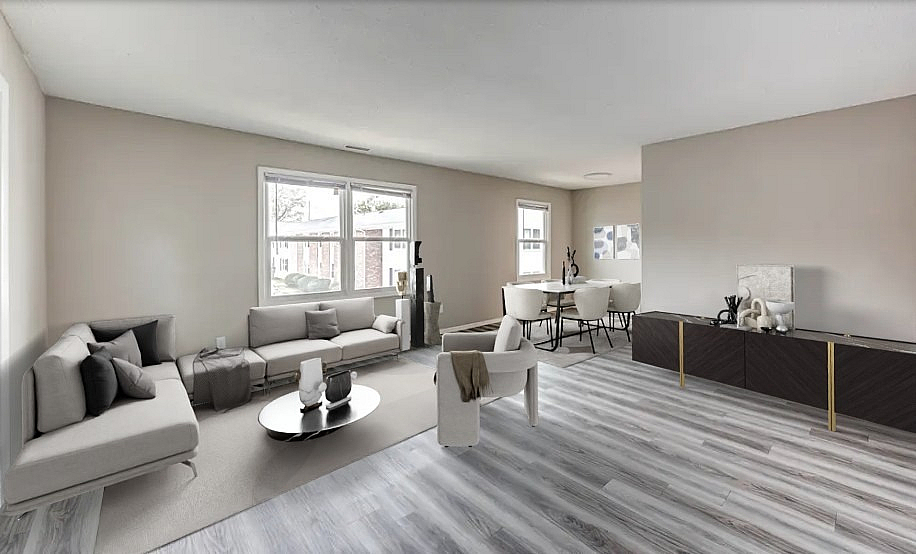 Modern apartment showcasing a bright open-plan living and dining area with elegant furnishings and large windows.