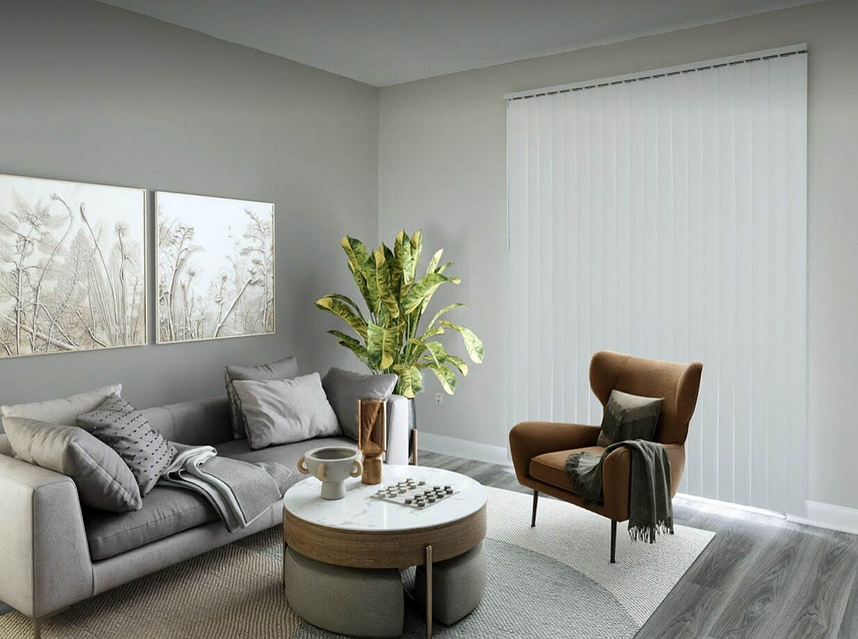 Chic modern living room with a stylish gray sofa, elegant artwork, and lush green plant accents, creating a cozy and inviting atmosphere.