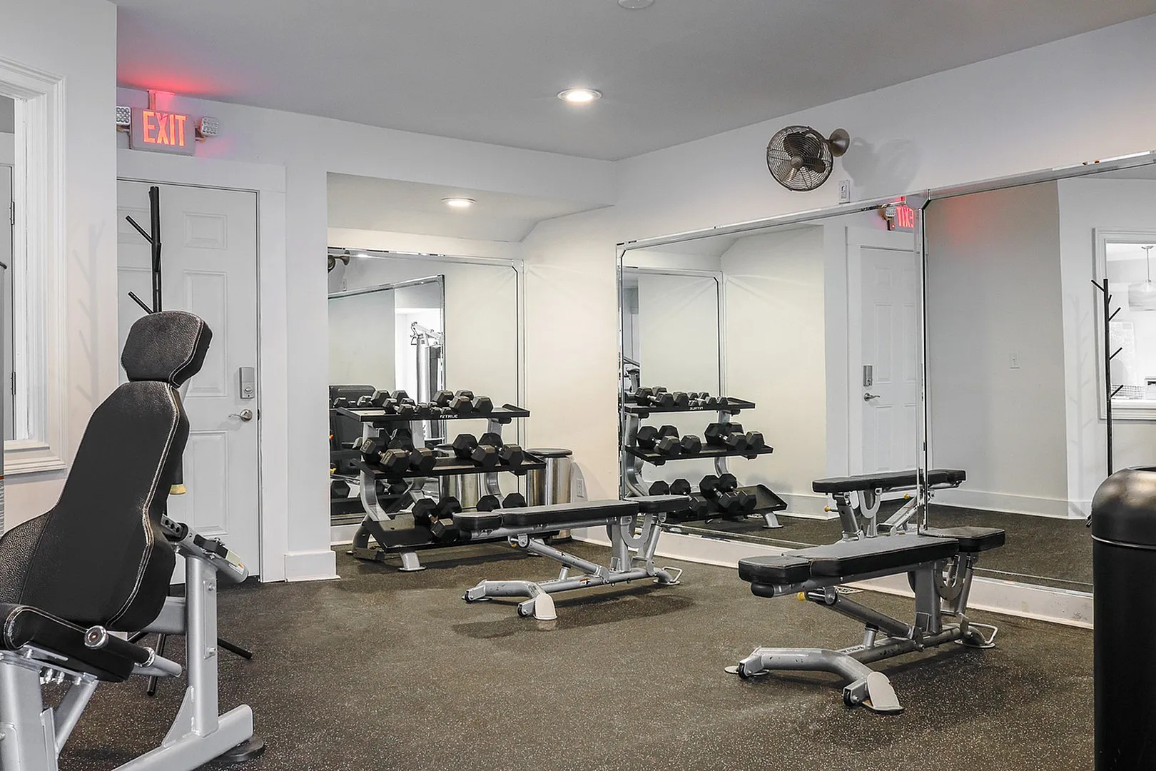 Modern fitness center with sleek equipment, mirrored walls, and natural light, perfect for an energizing workout.