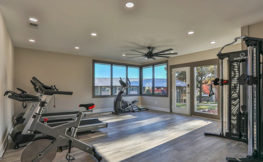Bright and modern home gym with state-of-the-art exercise equipment and scenic window views.