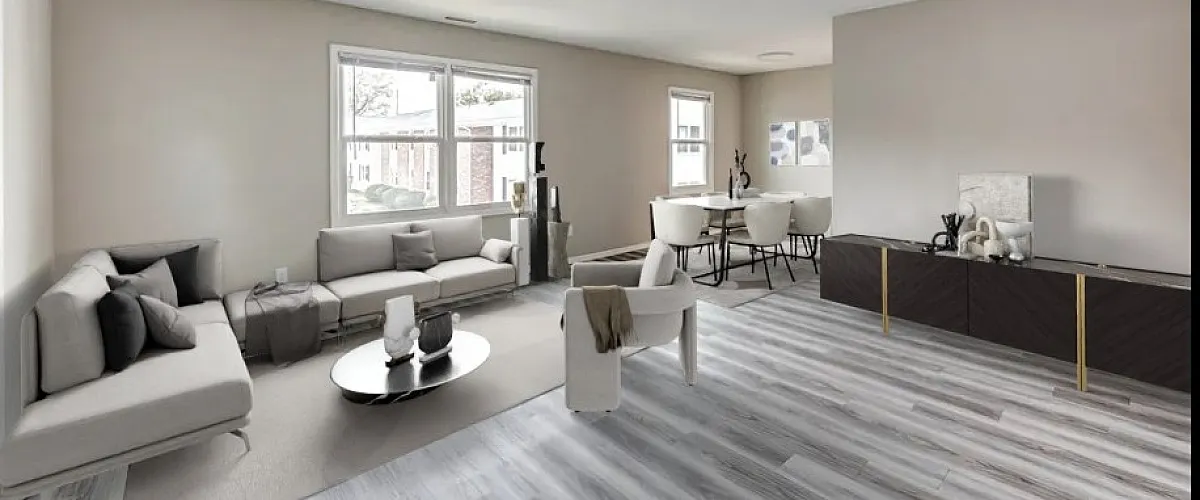 Bright and modern living room with stylish gray sofas, elegant dining area, and large windows offering ample natural light.