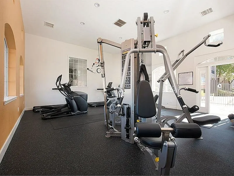 Bright and modern fitness center featuring state-of-the-art exercise equipment and natural lighting.
