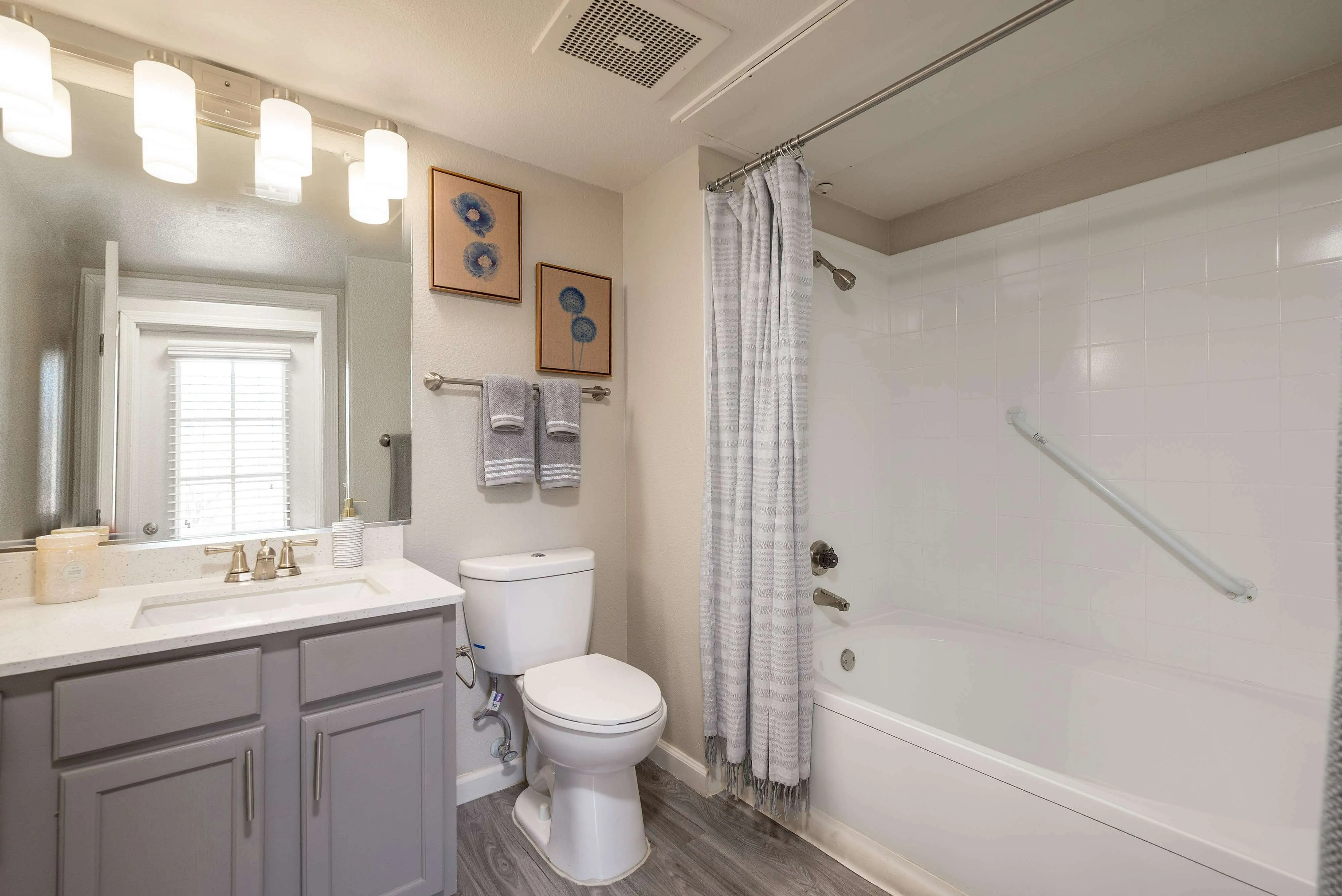 Elegant bathroom featuring modern fixtures, stylish lighting, and a calming gray color scheme.