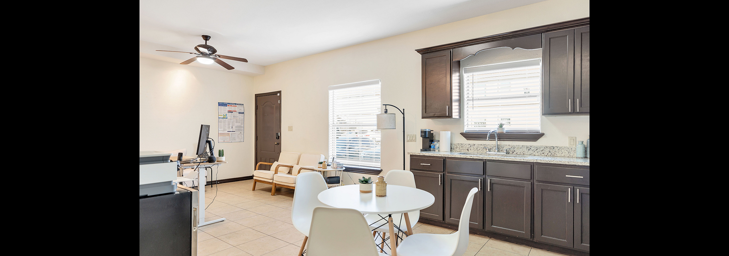 Chic open-plan living area with modern kitchen, cozy seating, and stylish dining set, perfect for entertaining.
