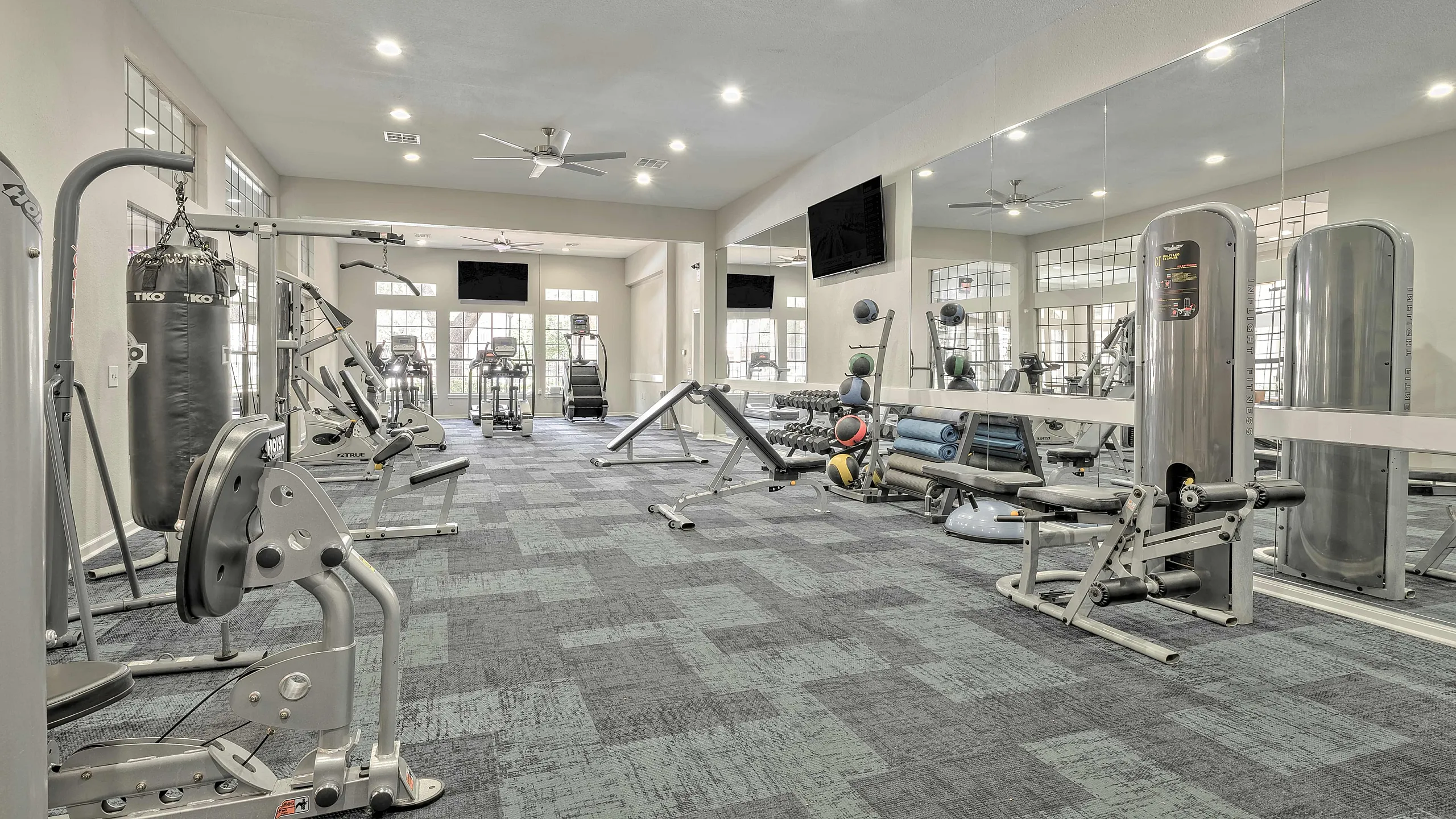 Spacious and modern fitness center with state-of-the-art exercise equipment and large mirrors.