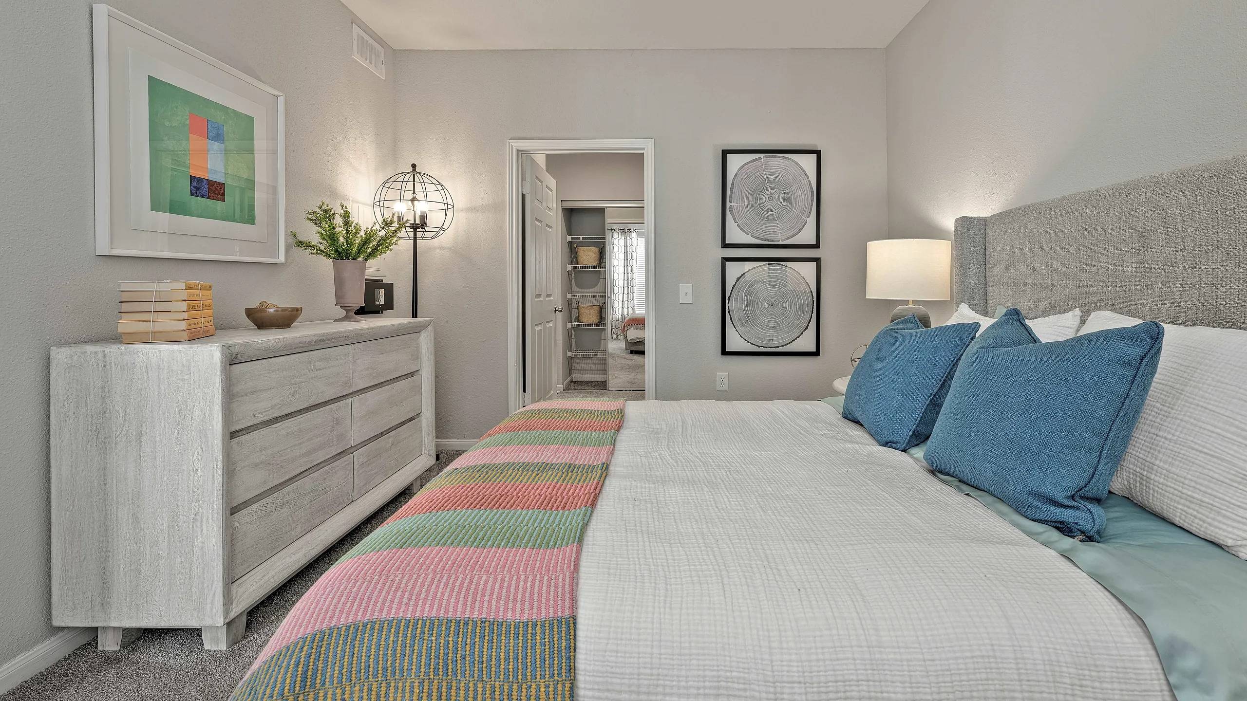Inviting bedroom with cozy decor, plush bedding, and stylish wall art, creating a serene retreat.