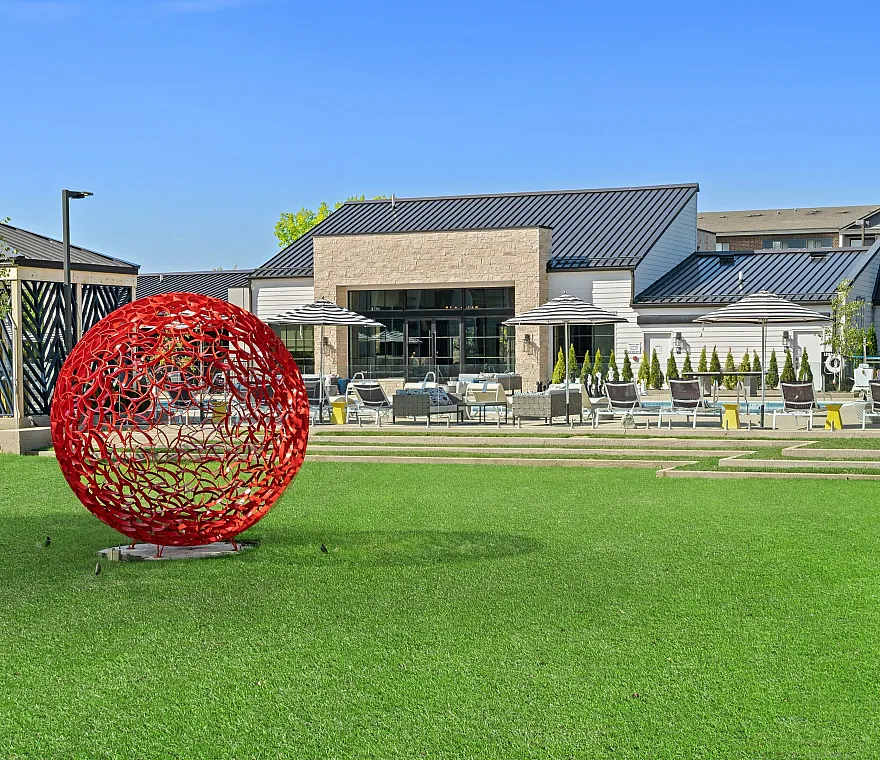 red sculpture and green yard