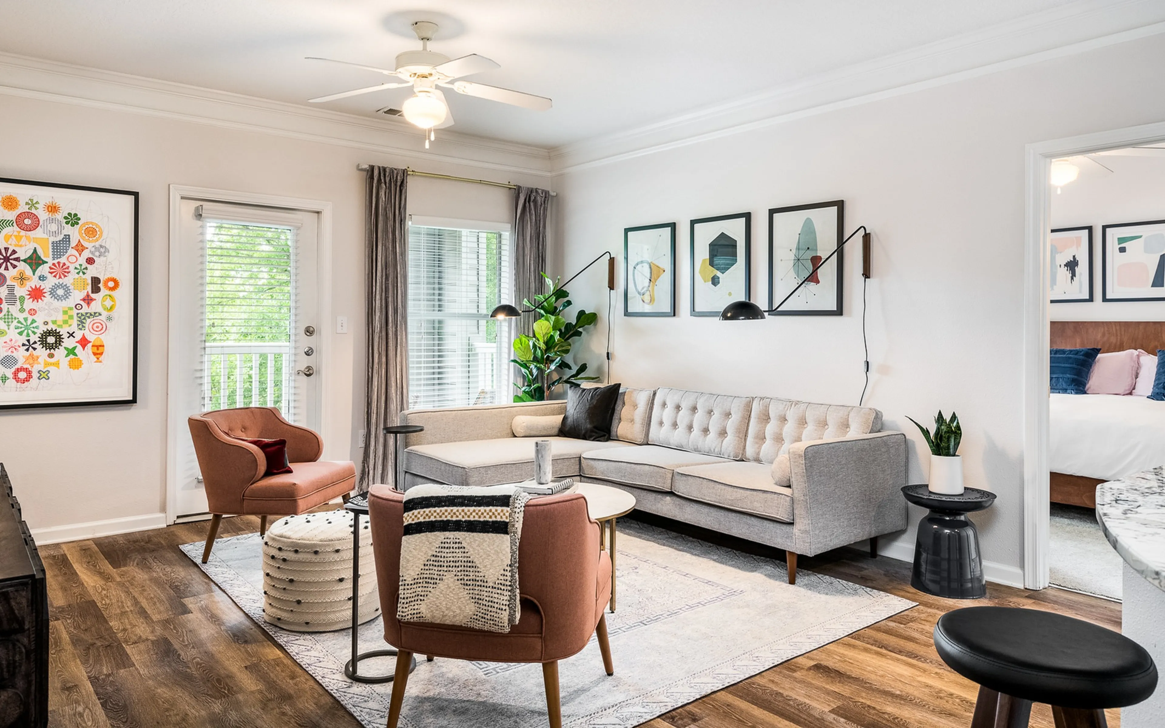 Stylish apartment living room with modern decor, cozy seating, and wall art.