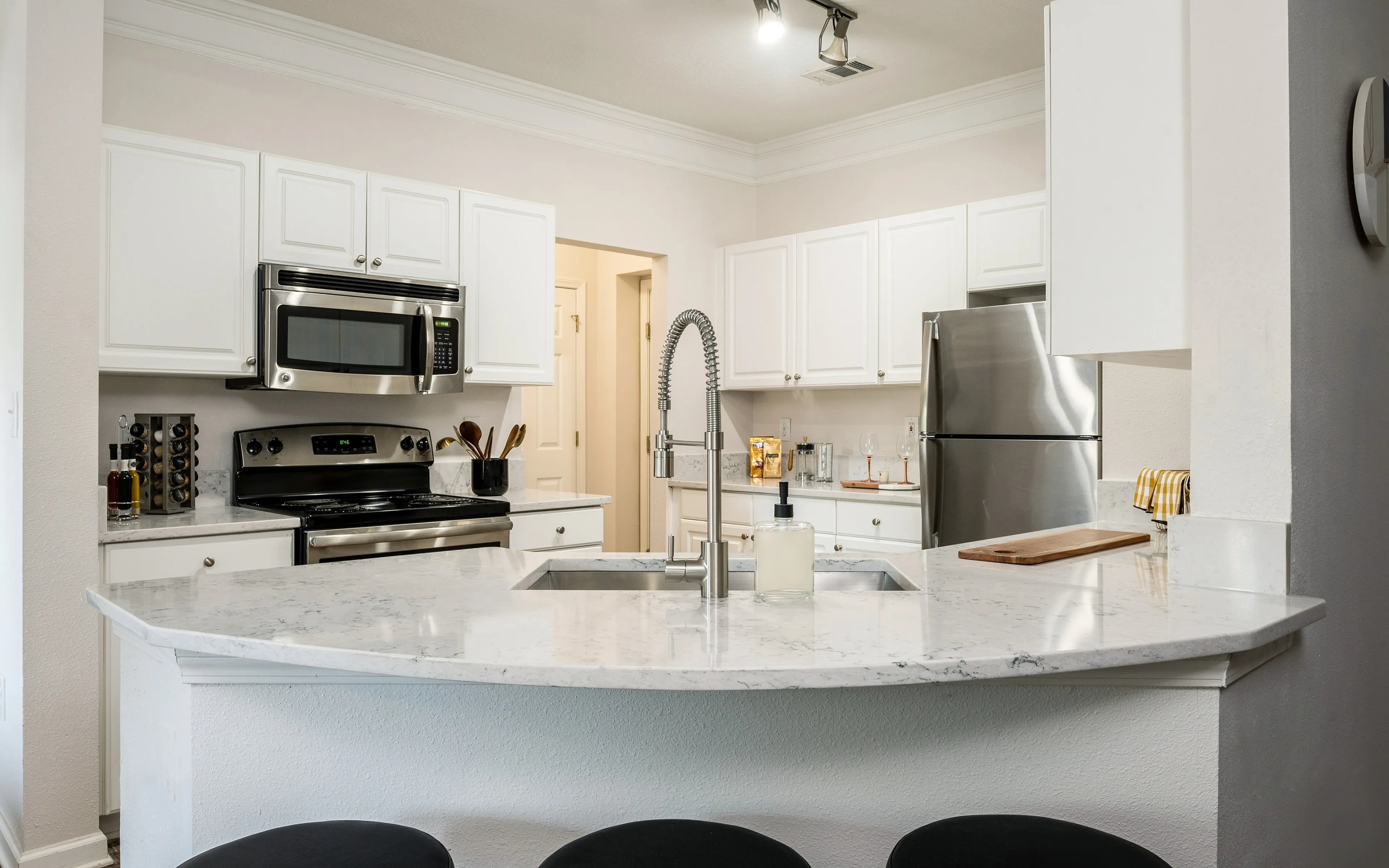 Sleek modern kitchen with marble countertop and stainless steel appliances