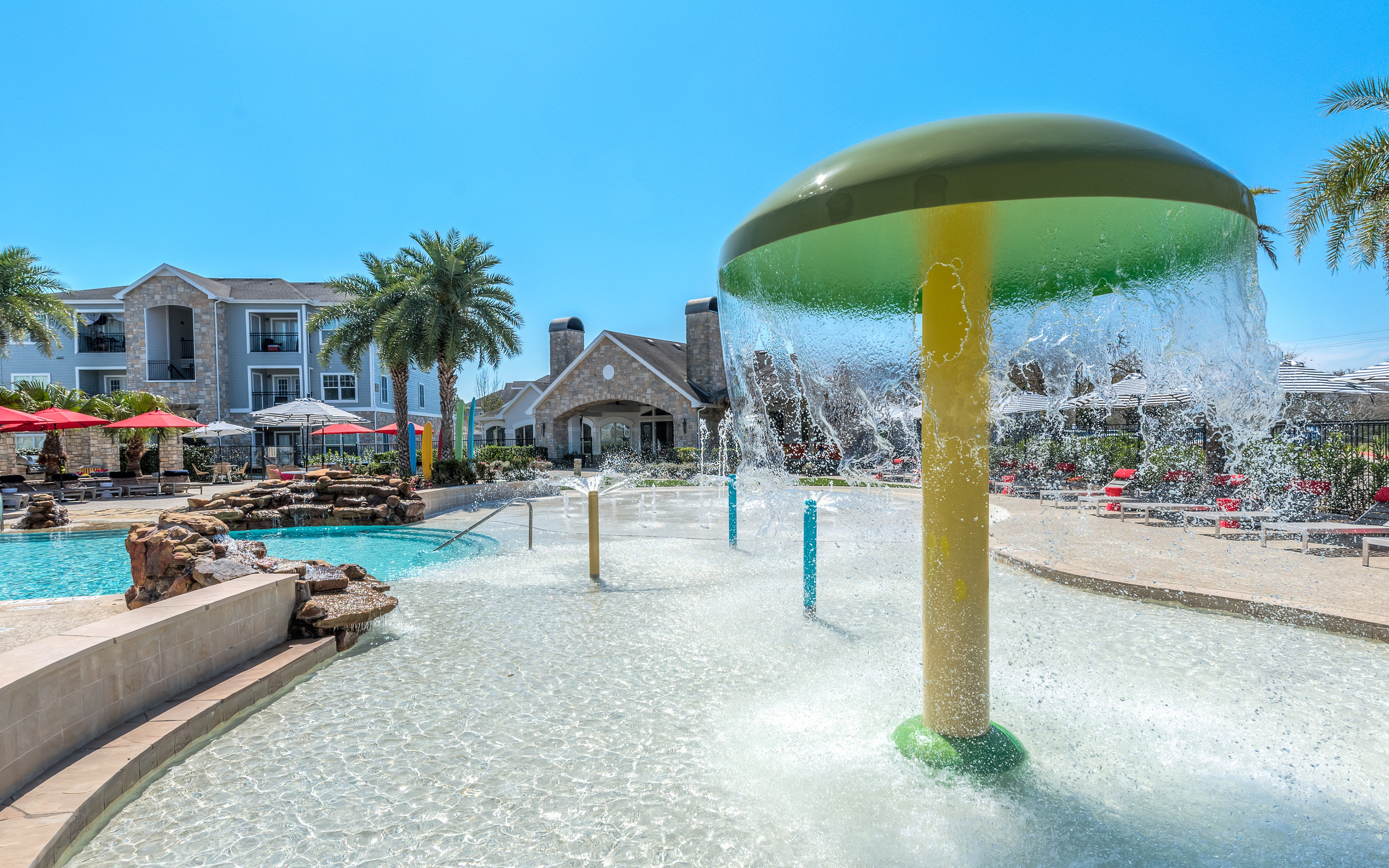 pool with fountain and splash pad