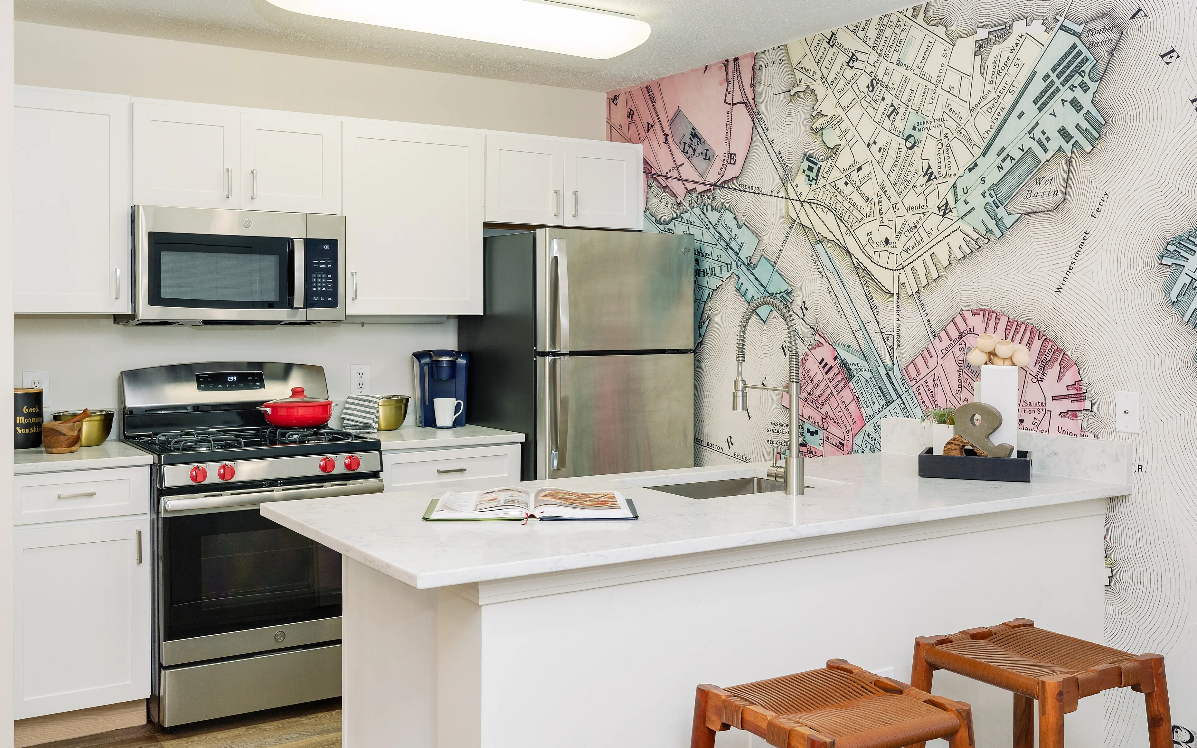 kitchen with stove, counter top, and map wallpaper