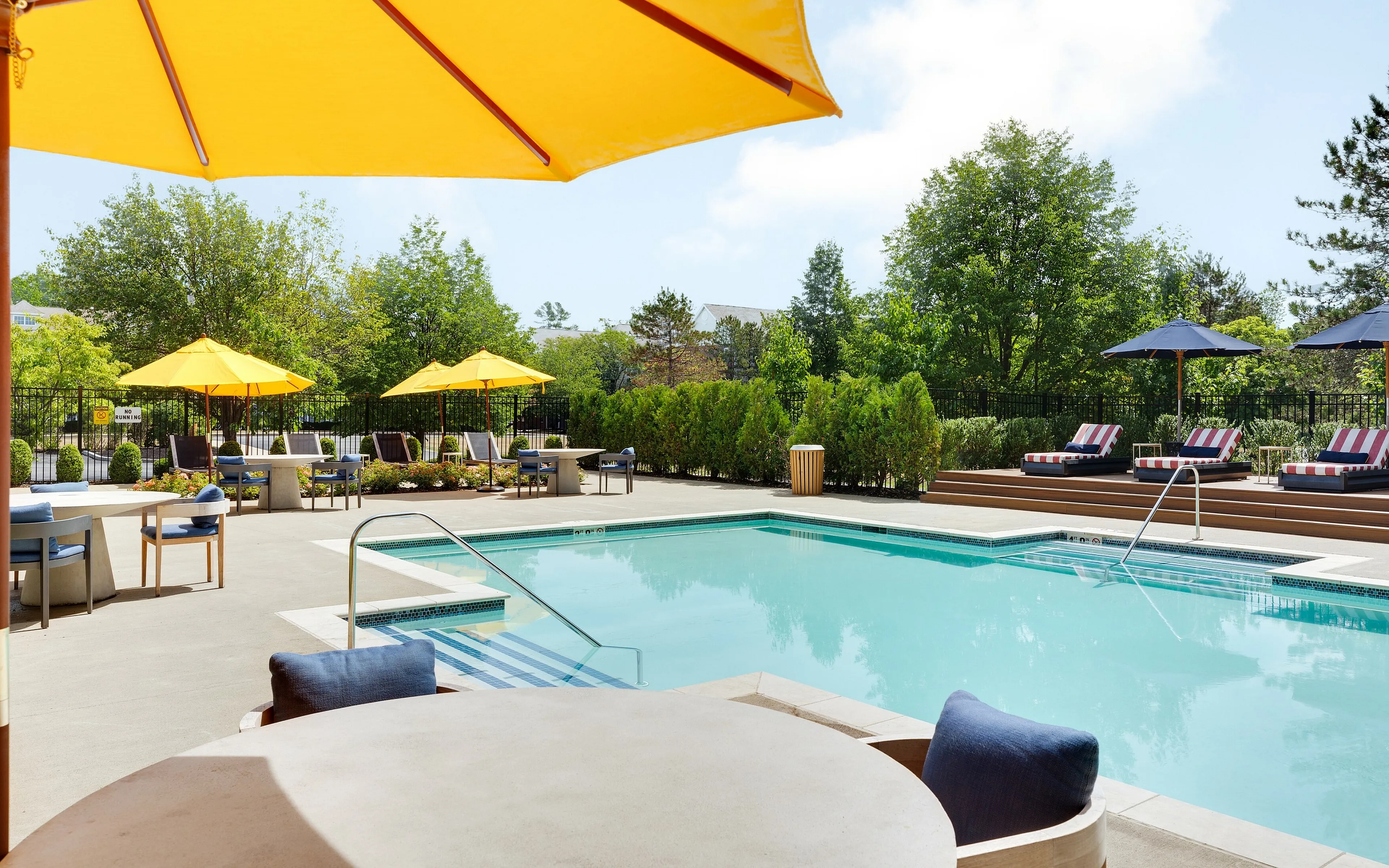 pool with yellow umbrella in foreground