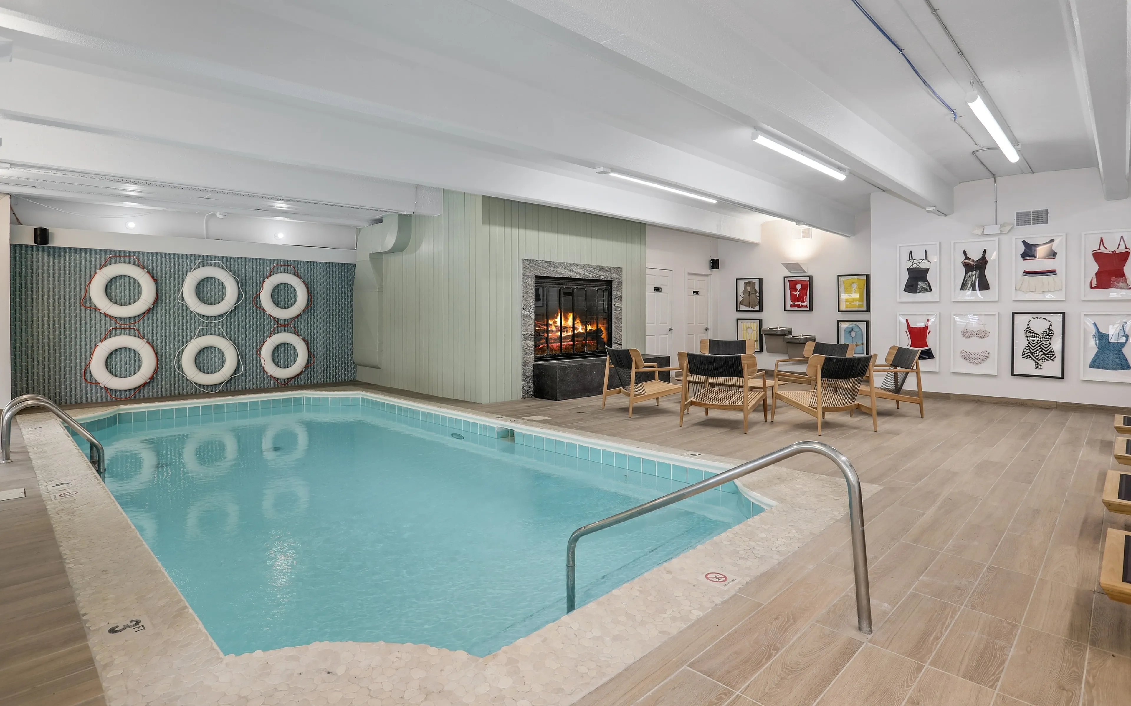 indoor pool with fireplace and seating in background