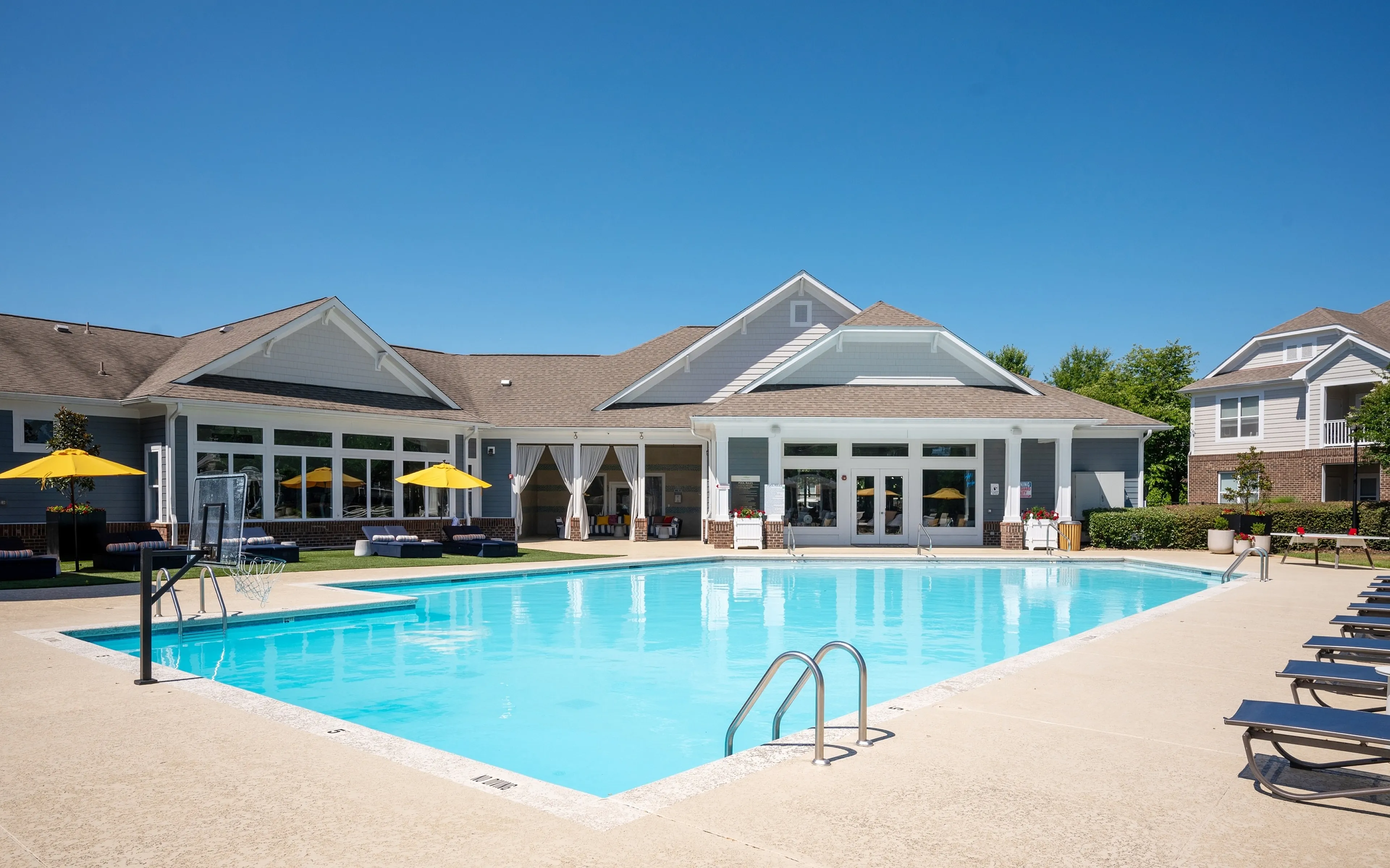 pool with clubhouse in background
