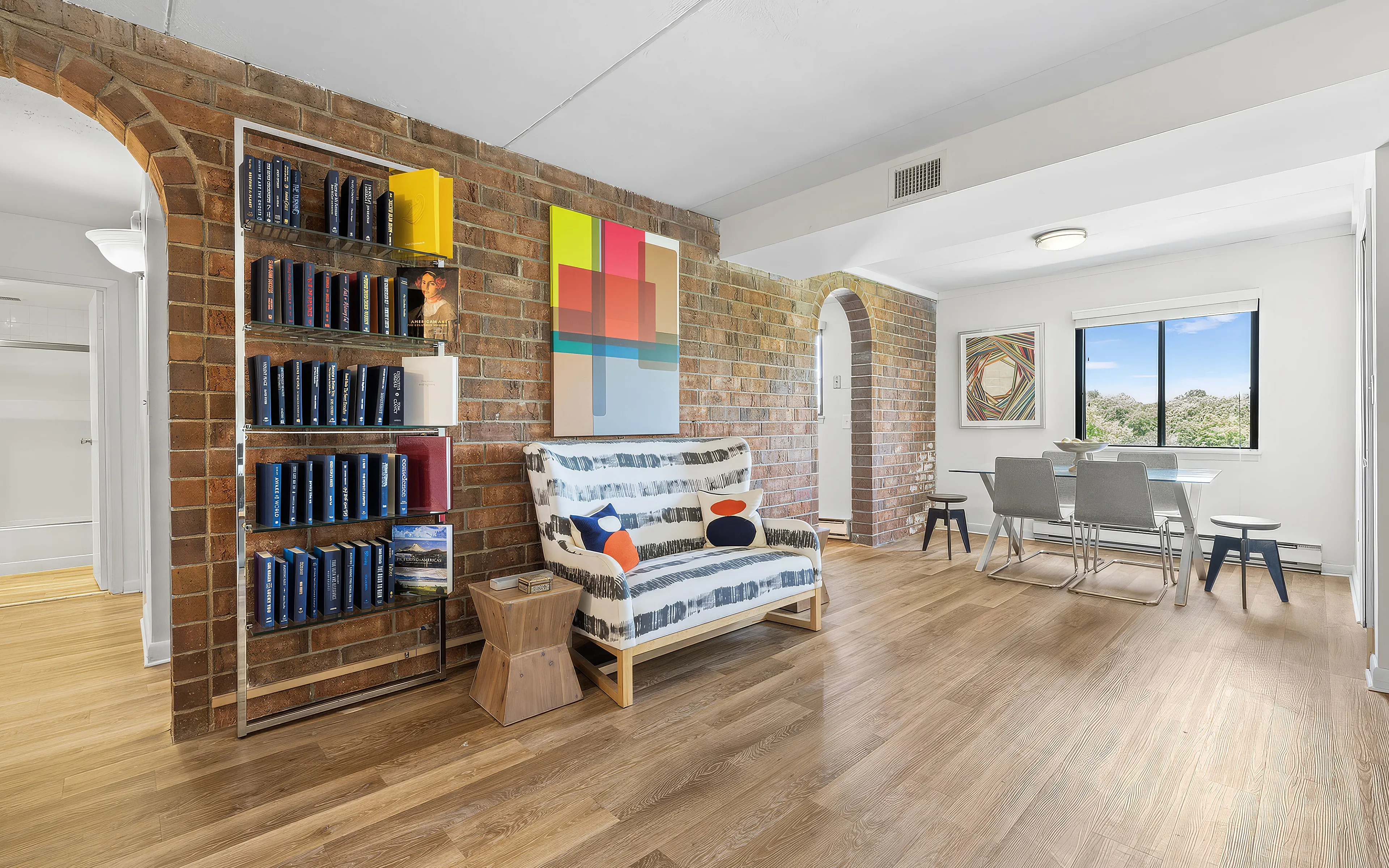 main living room showcasing brick wall