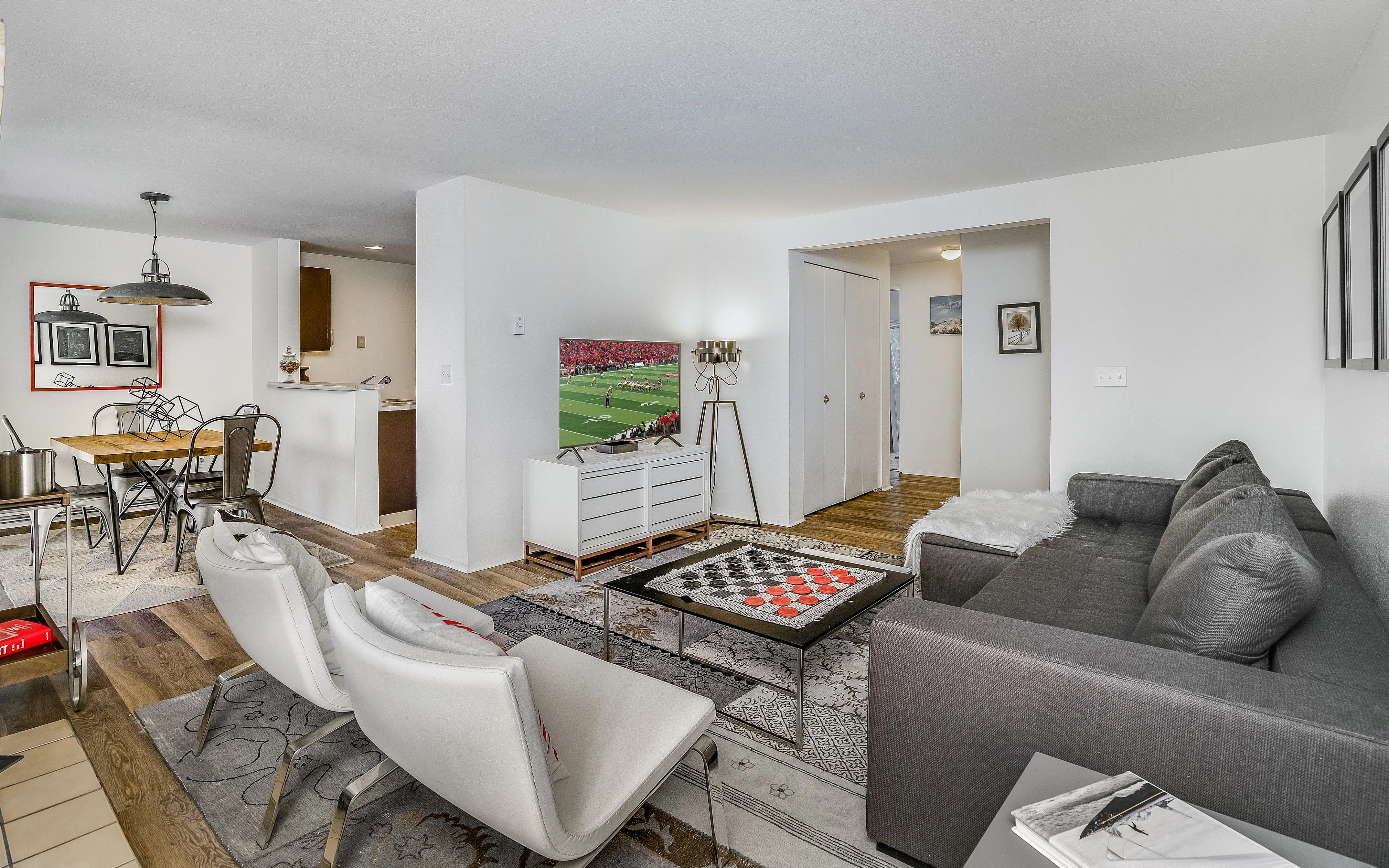 living room with white chairs and tv on