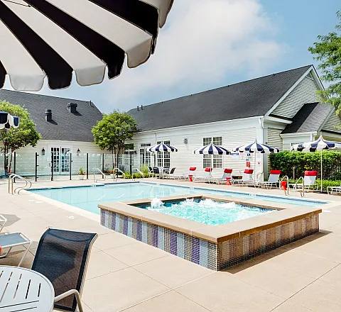 pool with lounge chairs and umbrellas