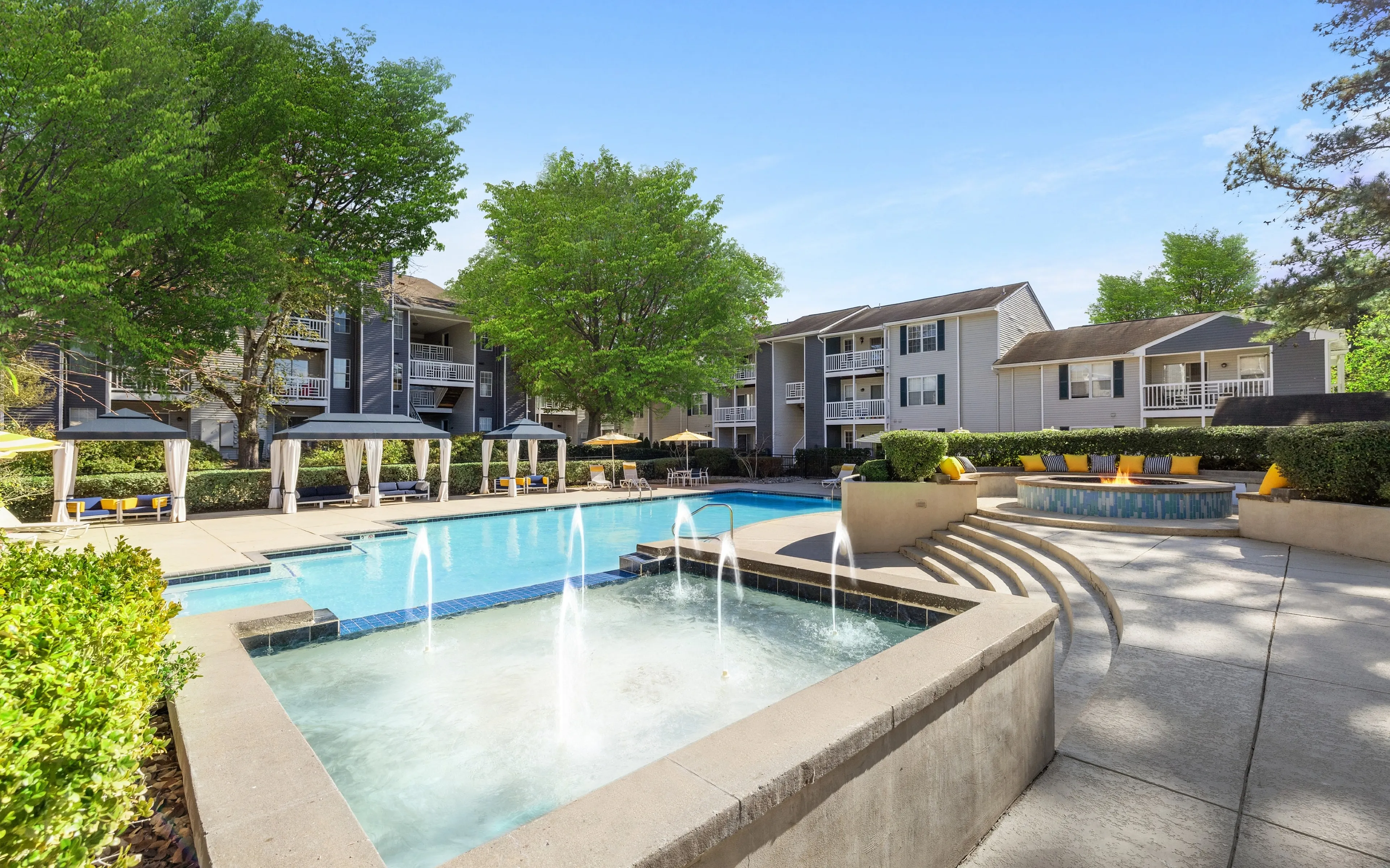 pool with fountain and buildings in background
