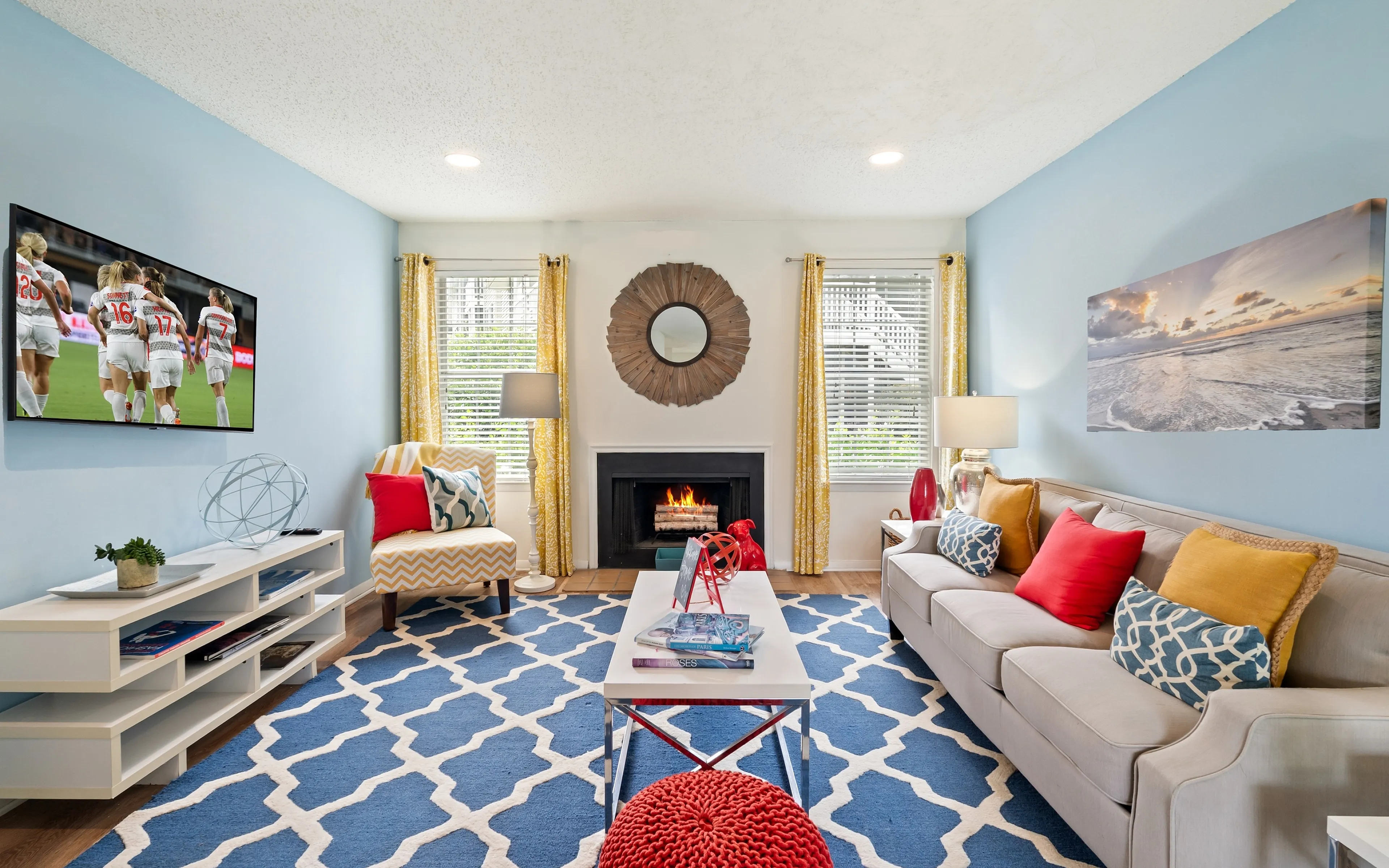 colorful living room with TV and fireplace