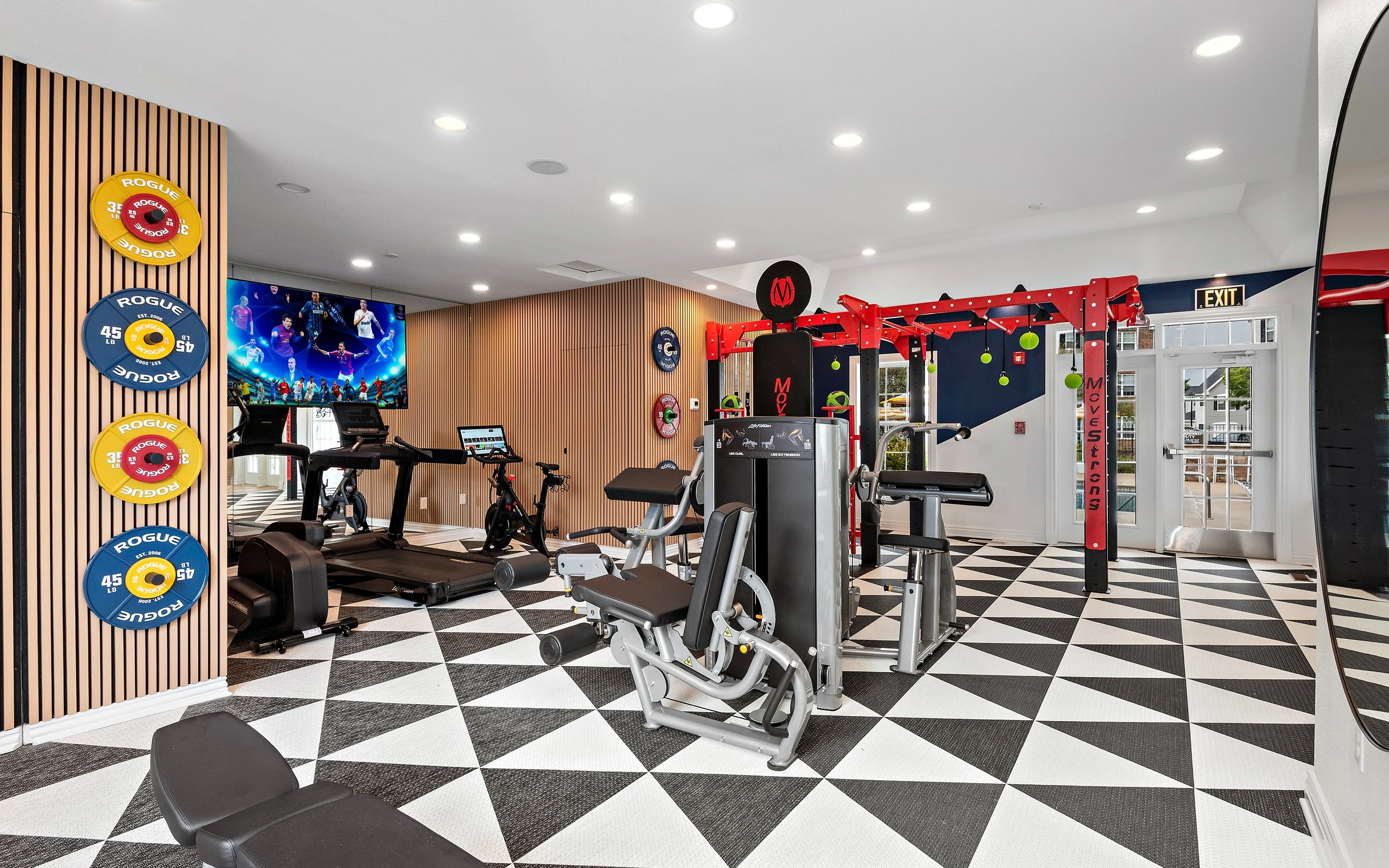 Vibrant fitness center with modern gym equipment, colorful weights, and sleek geometric flooring, perfect for energizing workouts.