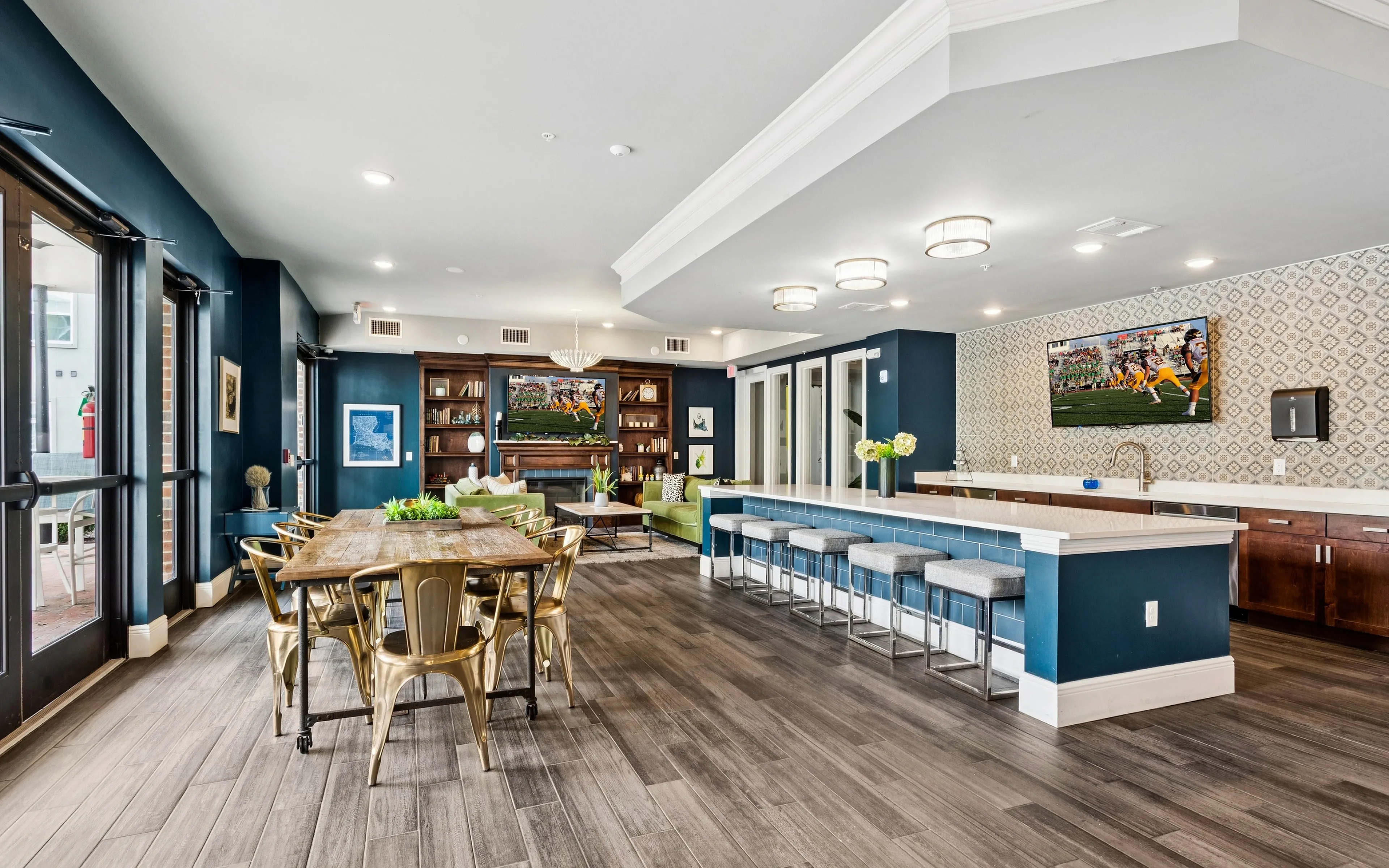 Chic communal lounge area featuring elegant wooden flooring, stylish bar seating, and a vibrant dining space, perfect for gatherings.