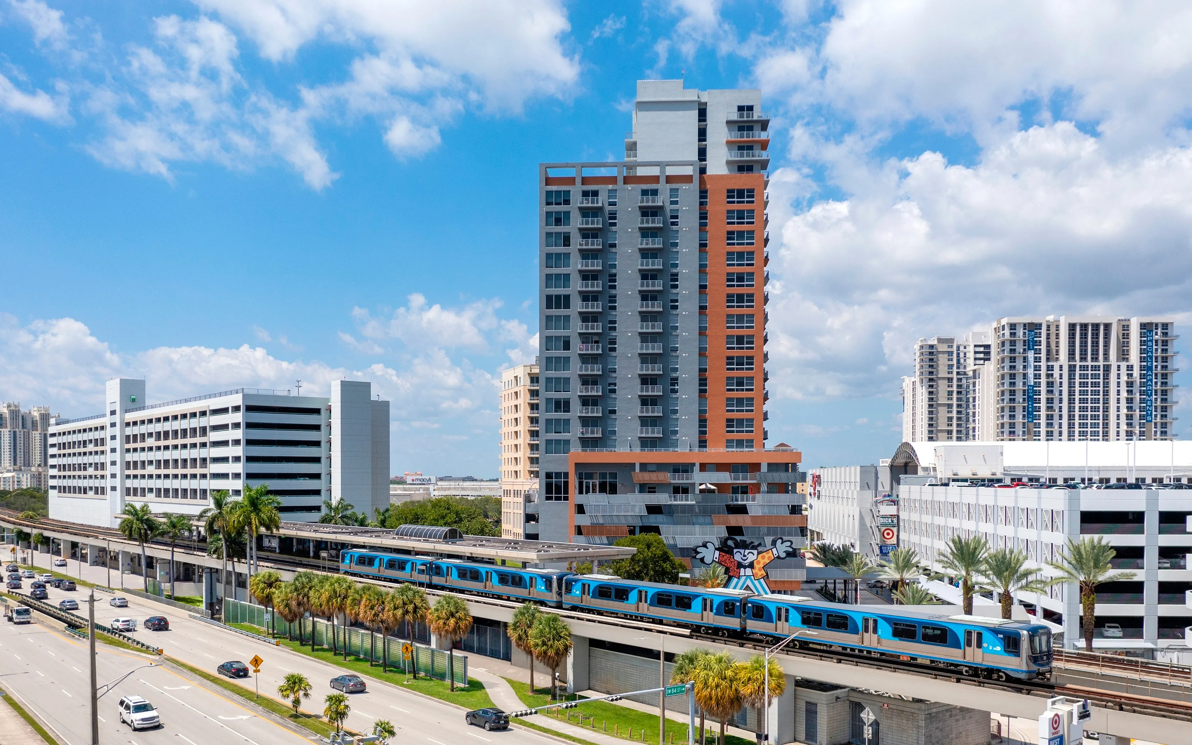 Vibrant urban scene showcasing a modern high-rise apartment with stylish architecture, adjacent to efficient public transit in a lively cityscape.