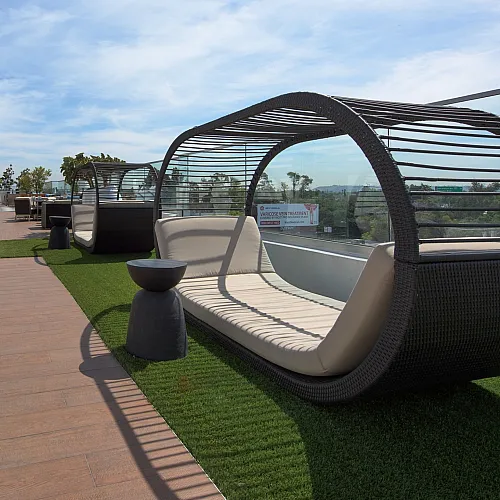 Stunning rooftop terrace with modern lounge seating and expansive views, perfect for relaxation under the open sky.