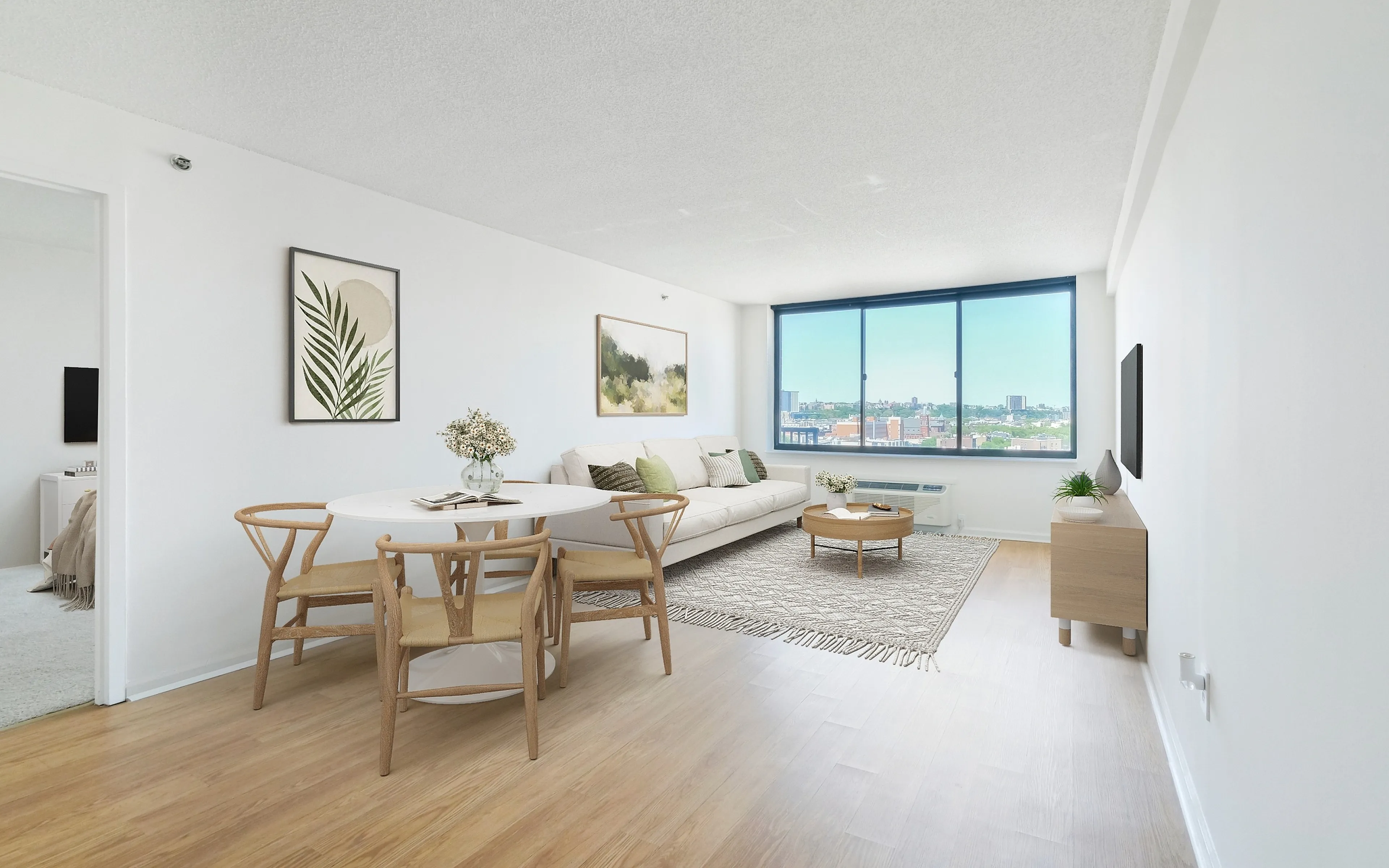 Bright and airy living space with modern decor, featuring large windows offering stunning city views and a cozy dining area.