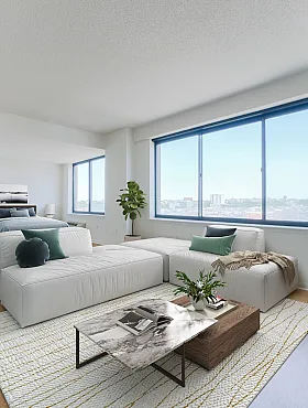 Bright and spacious open-plan apartment with modern furnishings, large windows, and inviting living area overlooking city views.
