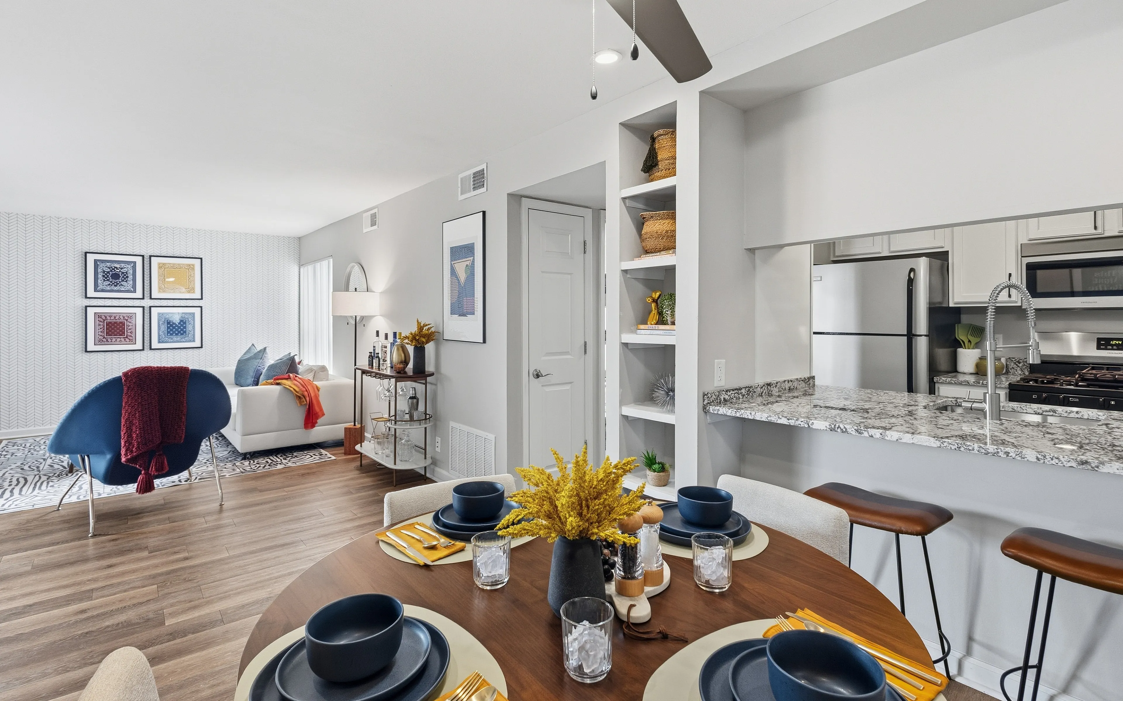 Chic open-plan living space with modern kitchen, cozy dining area, and stylish decor, perfect for entertaining.