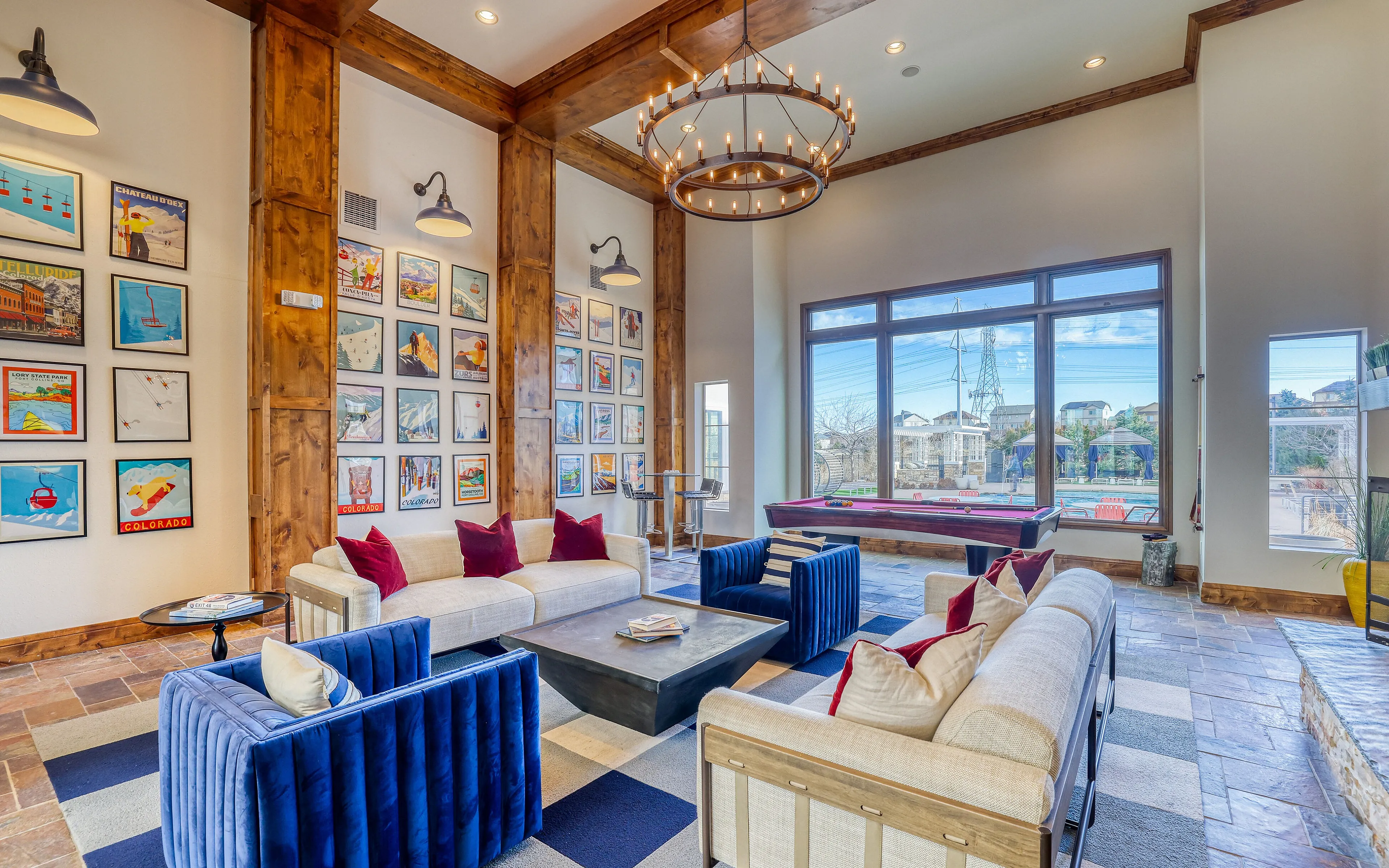 Inviting living space with modern decor, vibrant artwork, cozy seating, and large windows offering natural light.