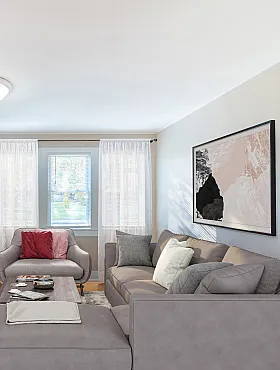 Inviting living room with elegant gray sectional sofa, stylish artwork, and abundant natural light.